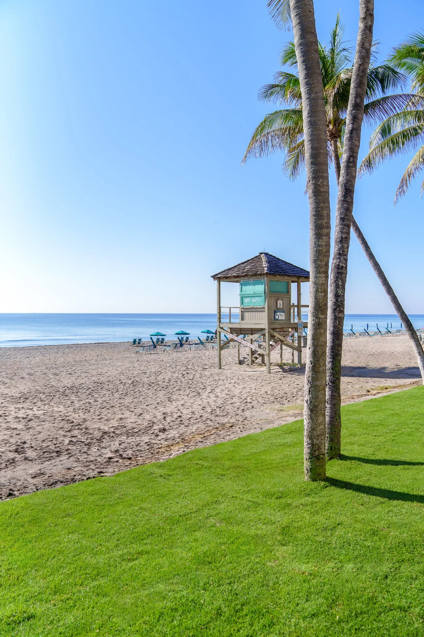 Lifeguard tower seen from a manicured beach lawn in South Florida