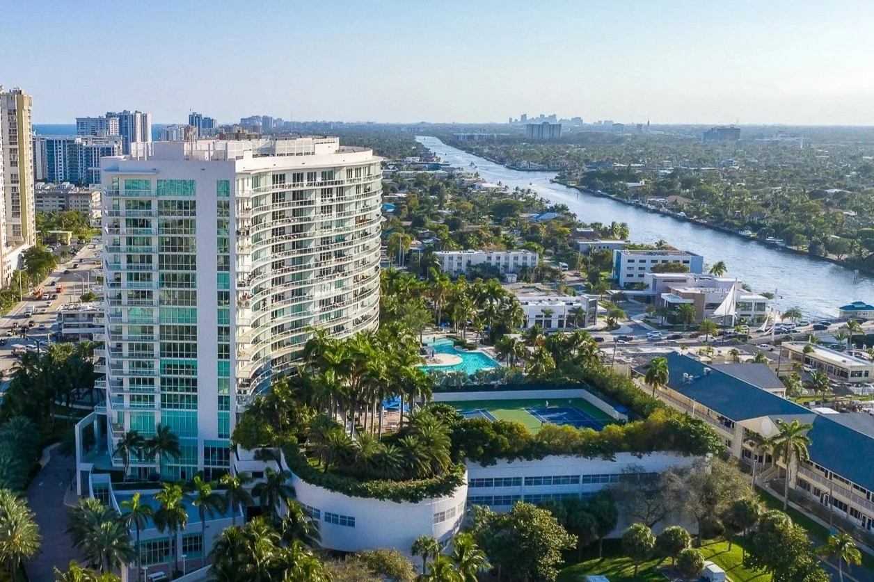 Golden hour aerial drone photograph of a luxury high-rise condominium overlooking the Intracoastal in Fort Lauderdale, South Florida