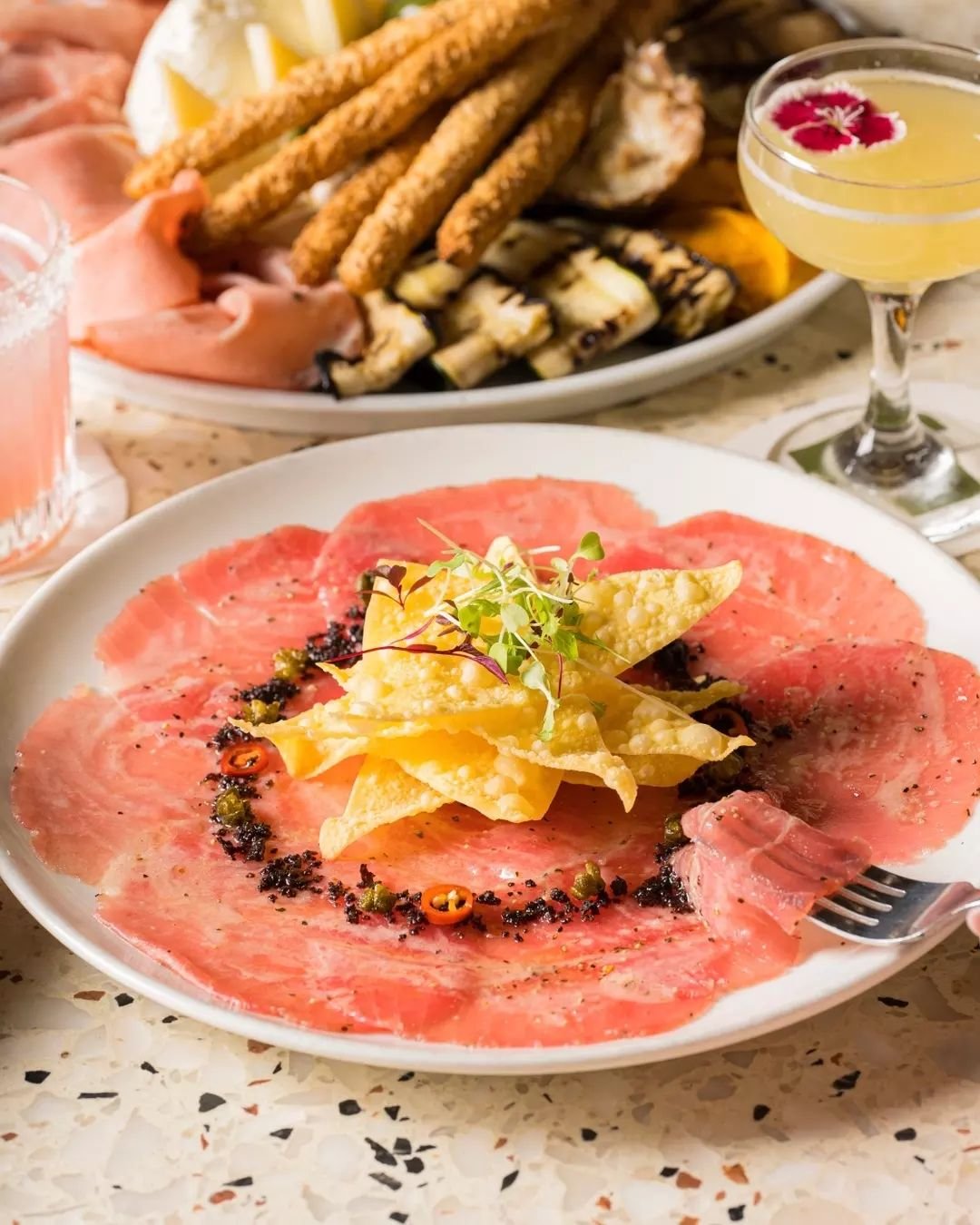 Our tuna carpaccio with fried baby capers, olive ash, sliced chilli &amp; lemon dressing.