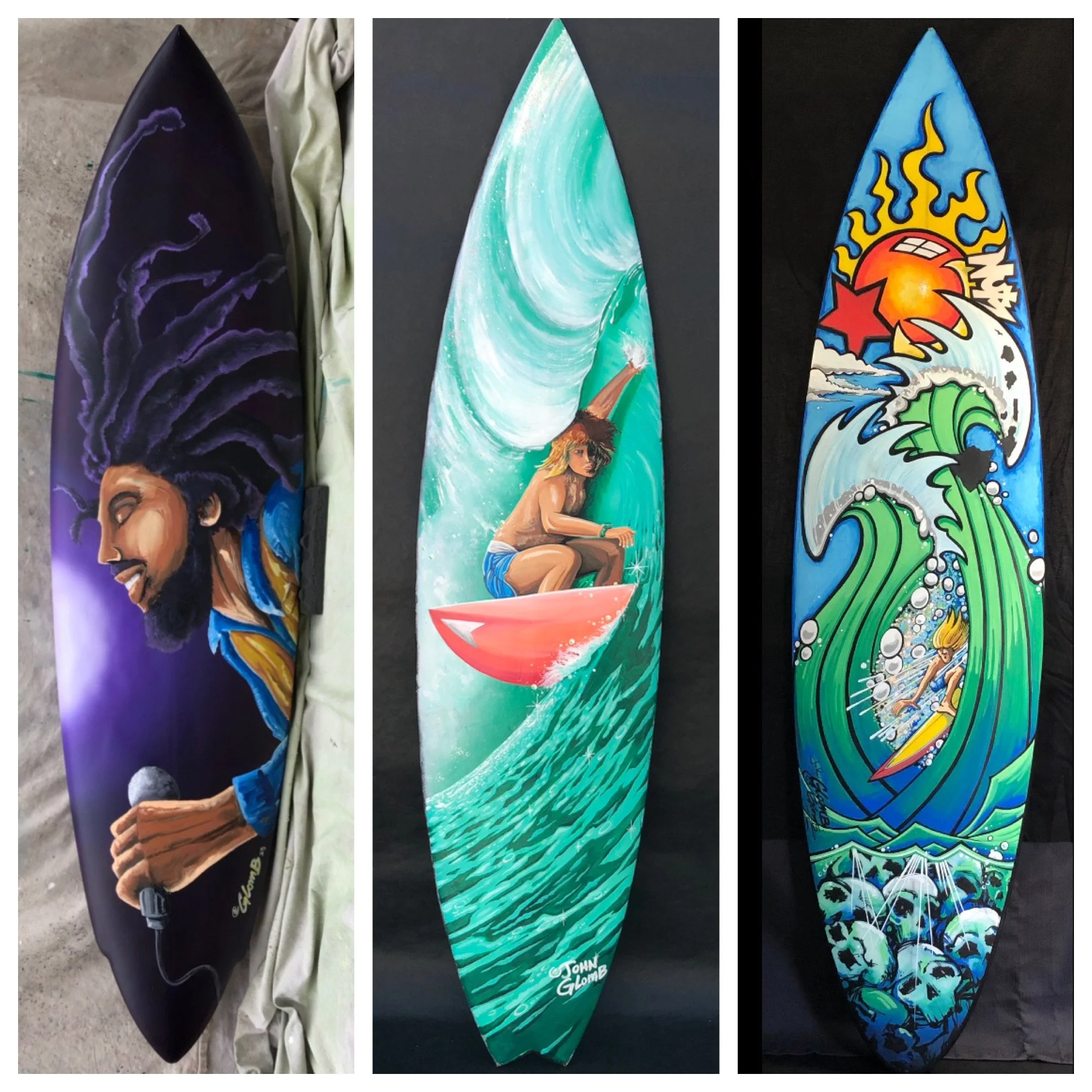 Three surfboards with colorful artistic designs. The first features a man with dreadlocks holding a microphone, the second shows a woman surfing a large wave on a pink surfboard, and the third depicts a woman surfing amidst green waves and a bright s