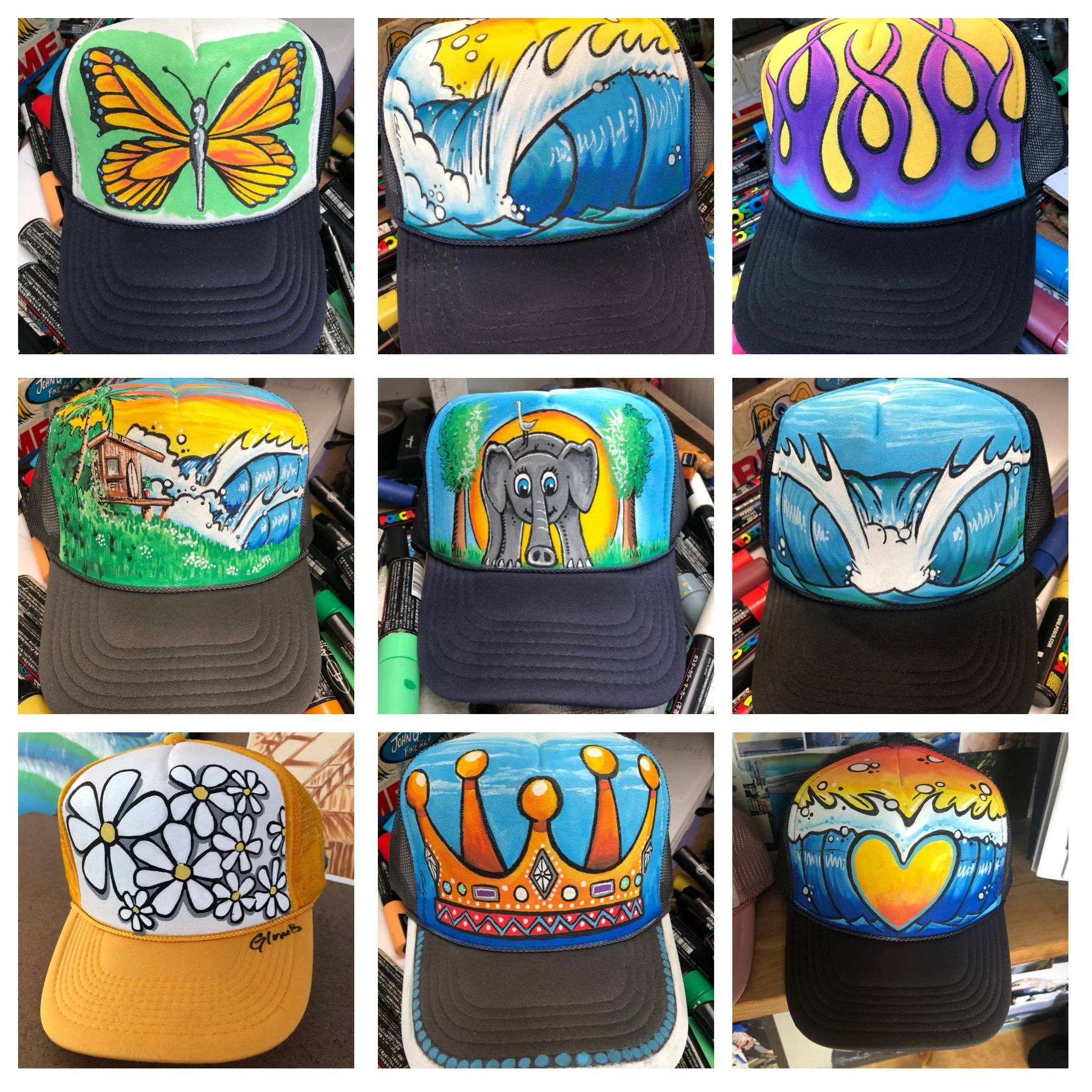 Collage of nine colorful trucker hats with hand-painted designs, including a butterfly, ocean waves, flames, a landscape, an elephant, water splash, daisies, a crown, and a heart.