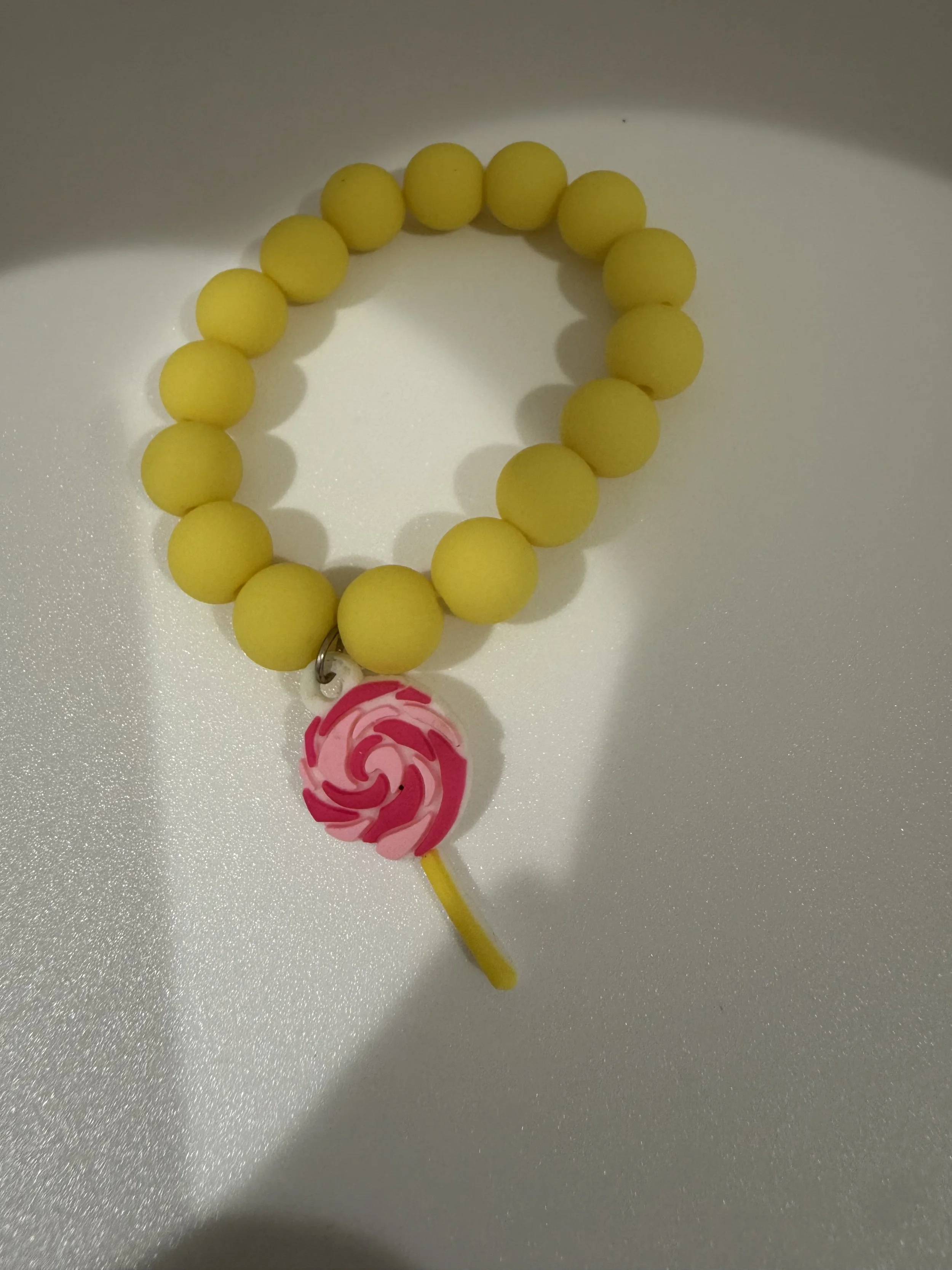 Yellow headed bracelet with lollipop charm