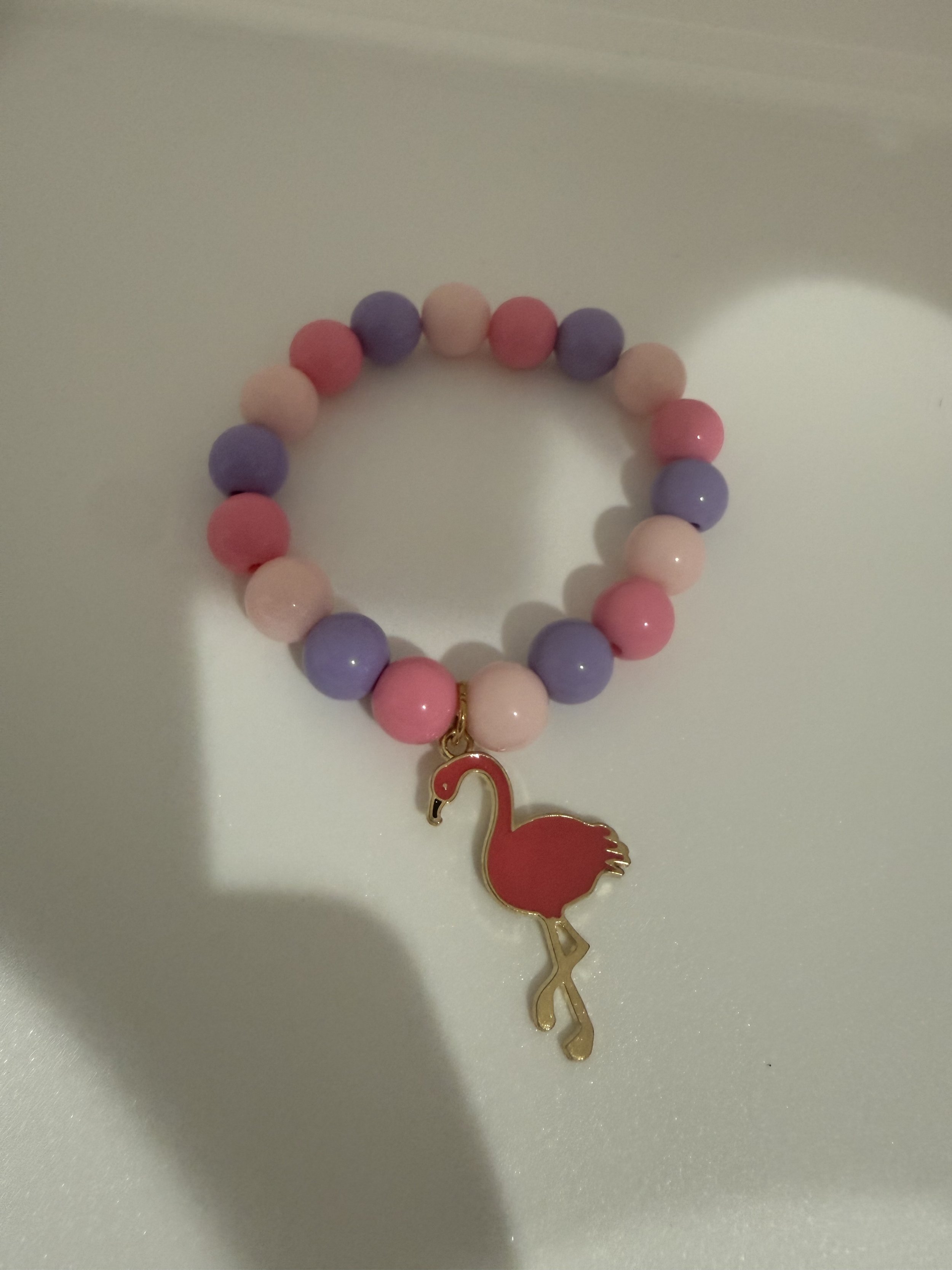 Pink and purple beaded bracelet with pink flamingo charm