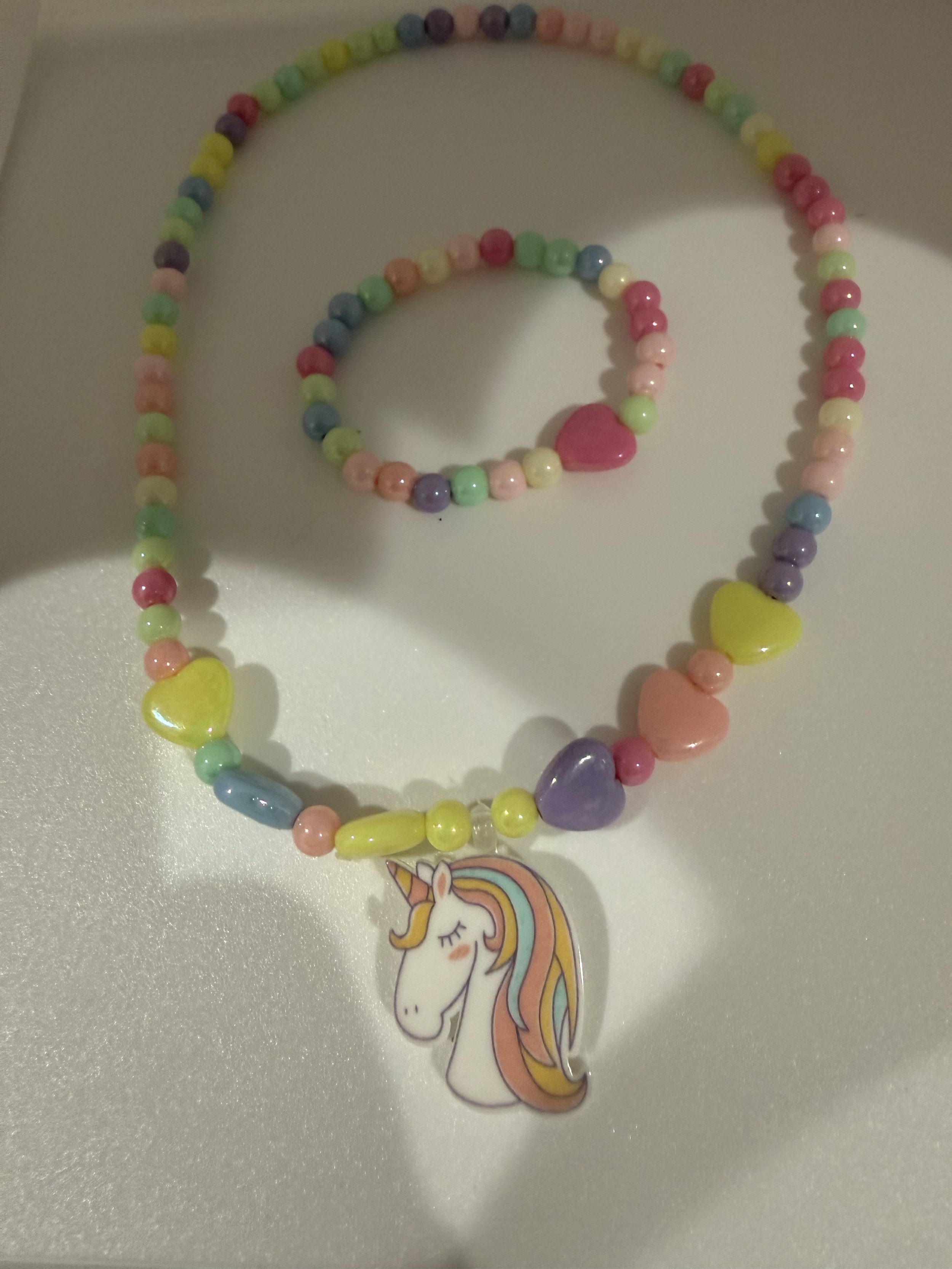 Multicolored beaded necklace and bracelet with hearts and unicorn charm