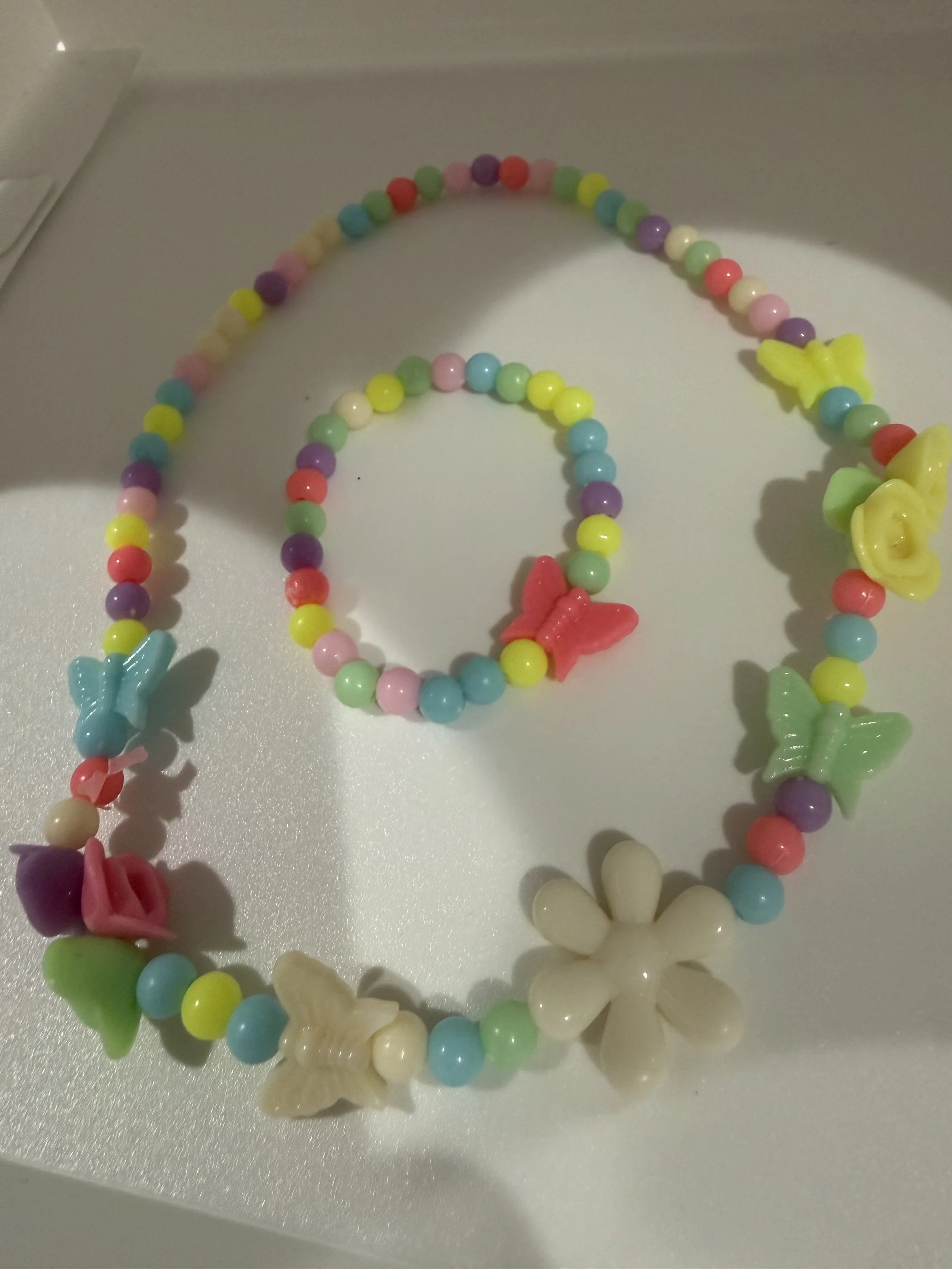 Multicolored beaded necklace and bracelet set with butterflies