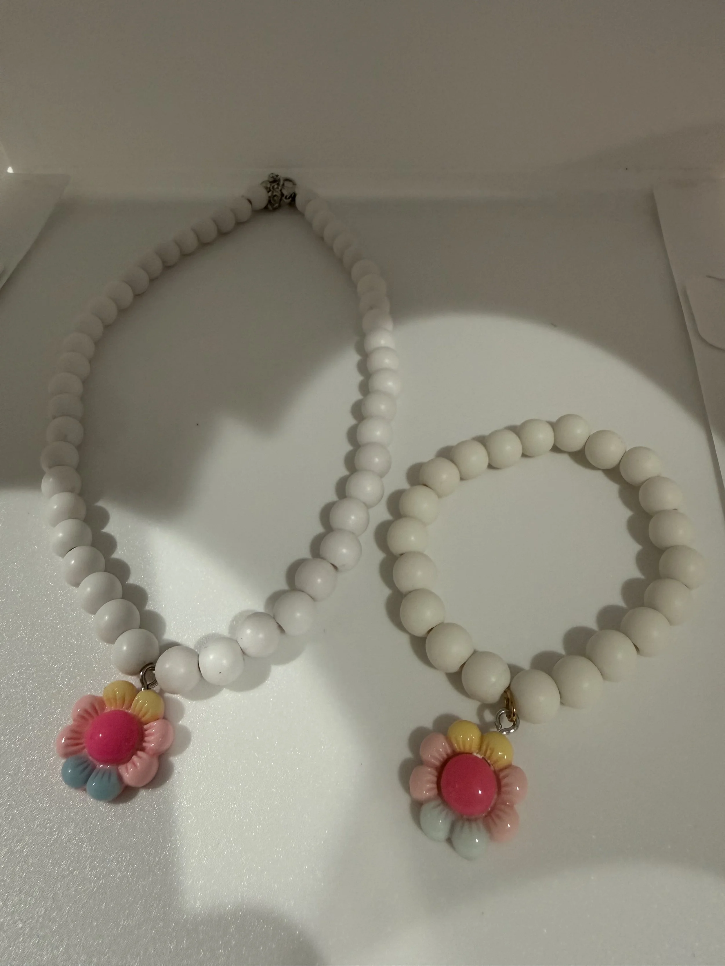 White beaded necklace and bracelet set with flower charm
