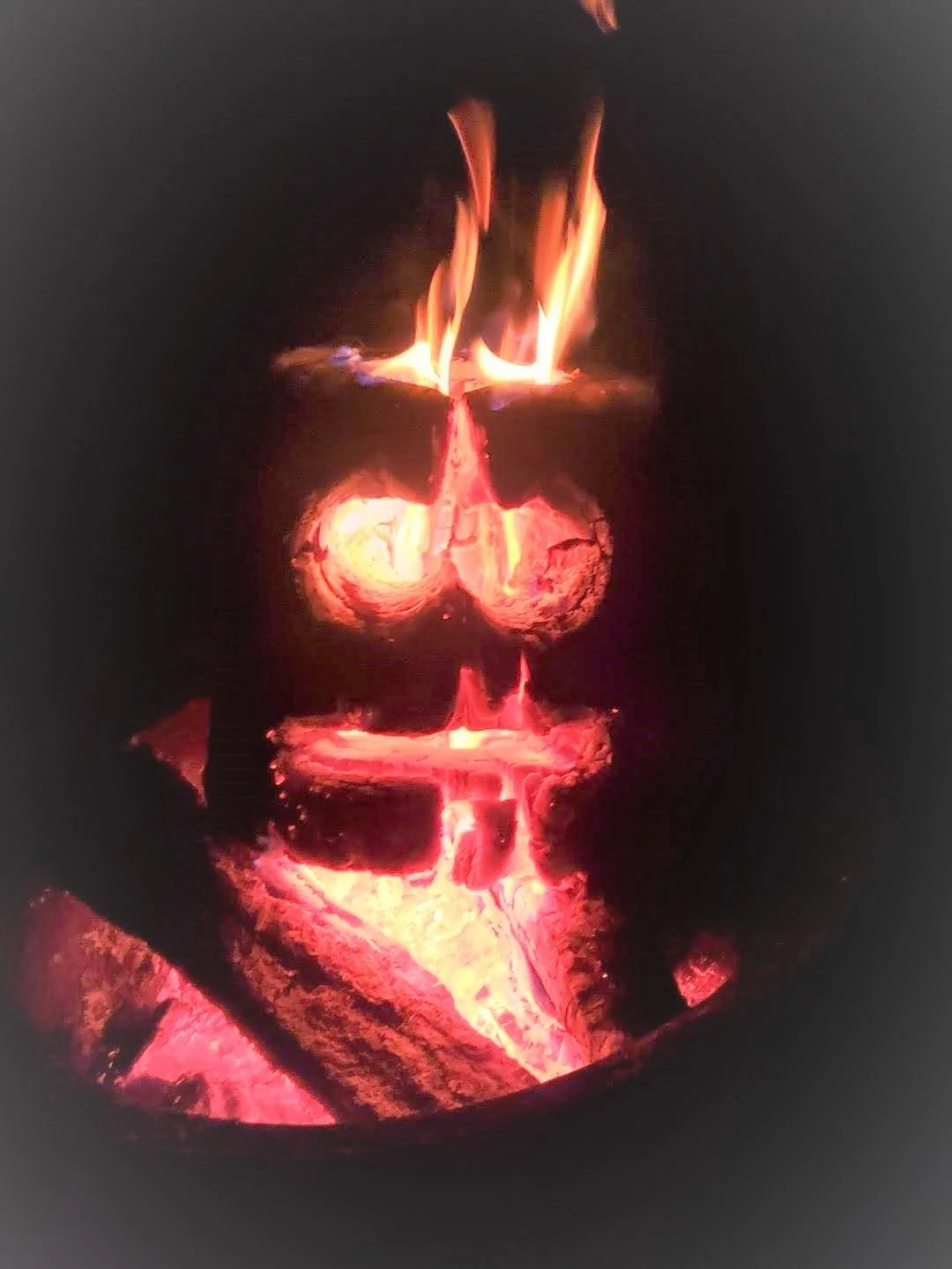 campfire log with smiley face