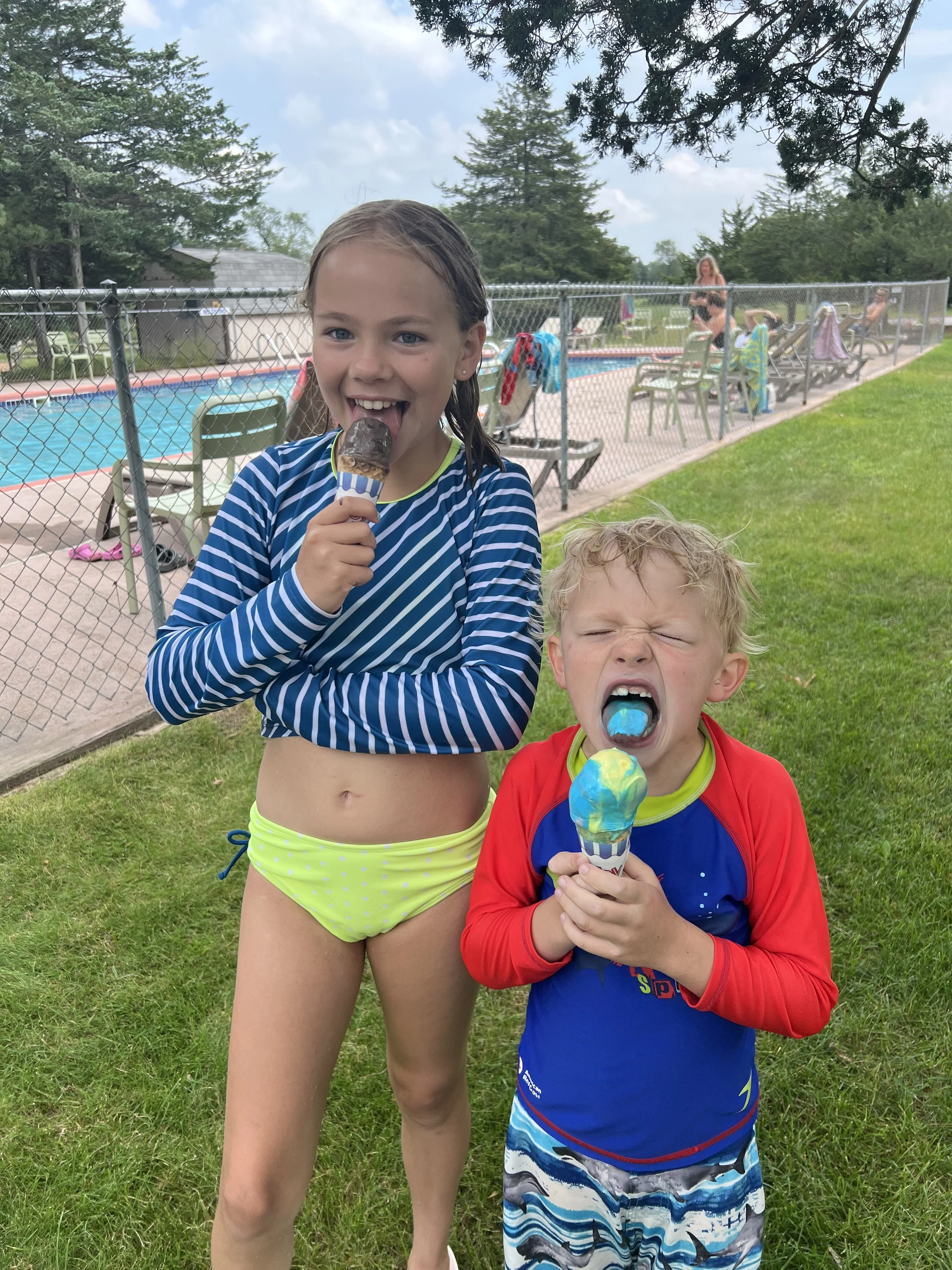 kids licking ice cream cones by pool at Dell Pines Campground near Wisconsin Dells