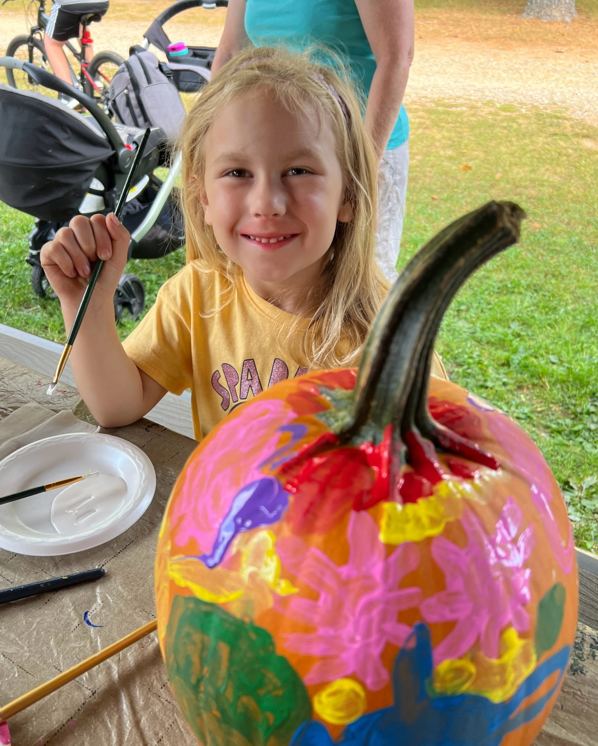 girl painting pumpkin