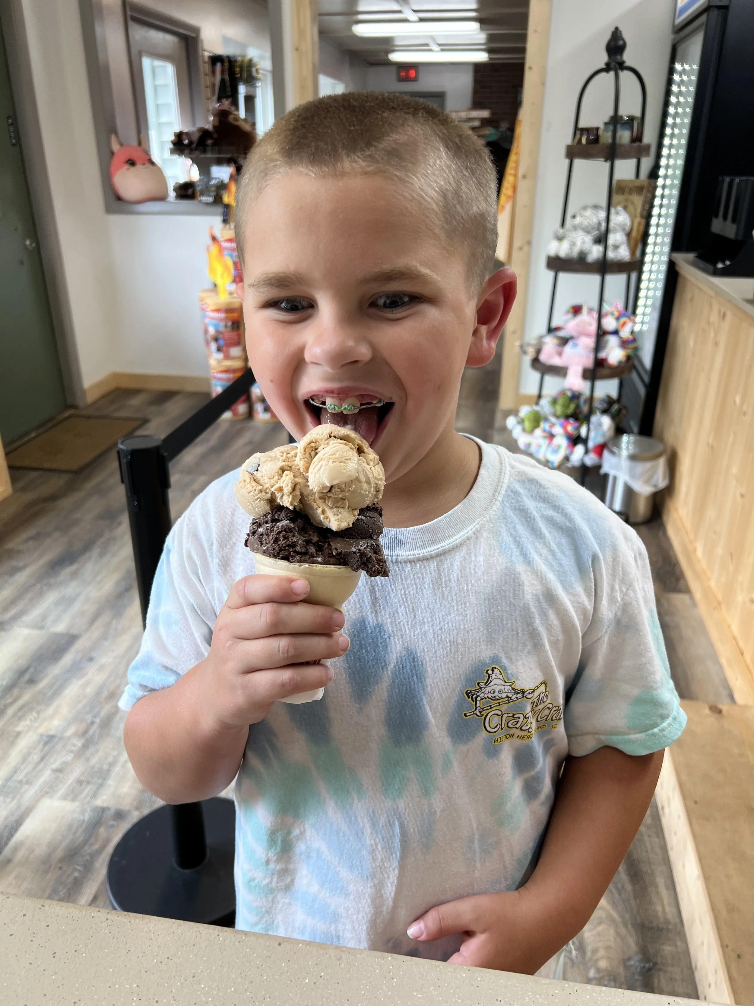 boy licking double scoop ice cream cone