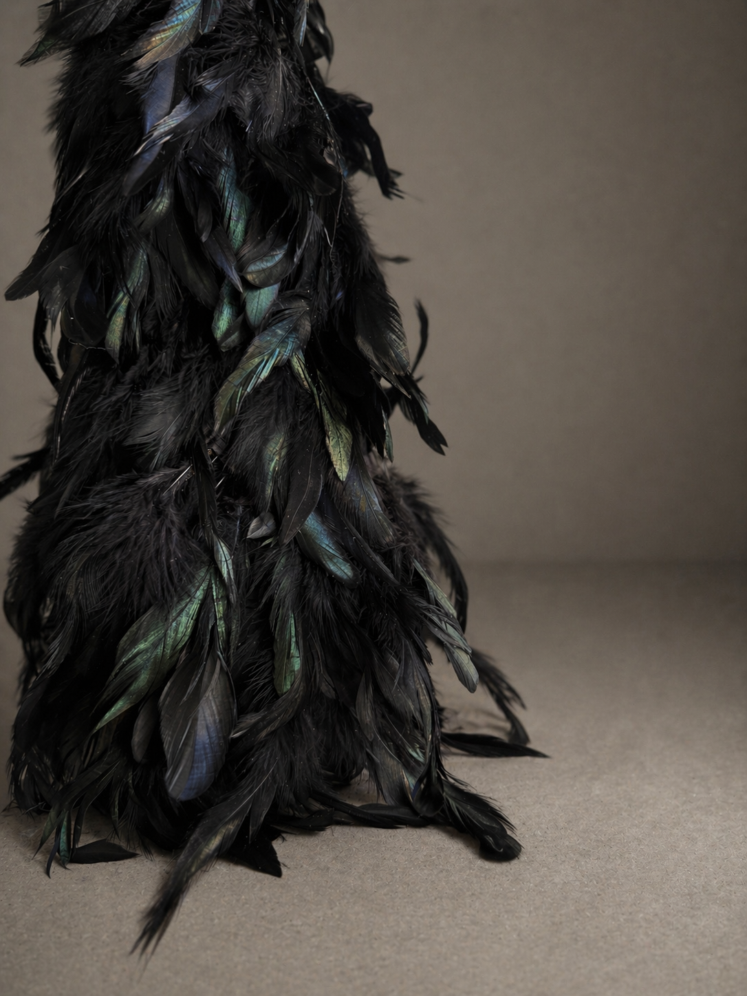 Black feather wrapped drink table with round top holding a martini glass, 24 inches tall, 10 inch diameter — Plume Drink Table