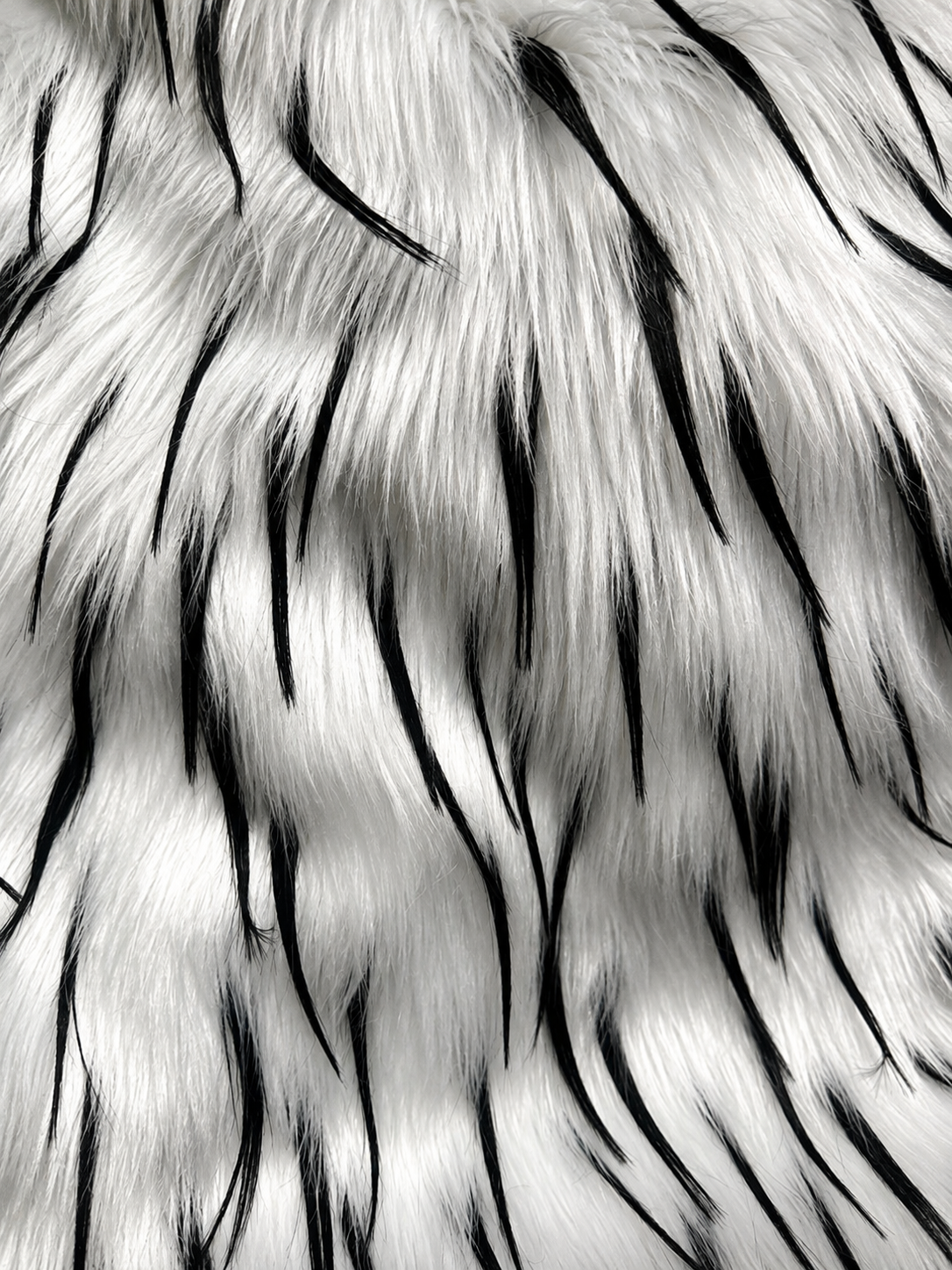 Close-up of the dimensional faux fur and contrasting thorn-like fibers