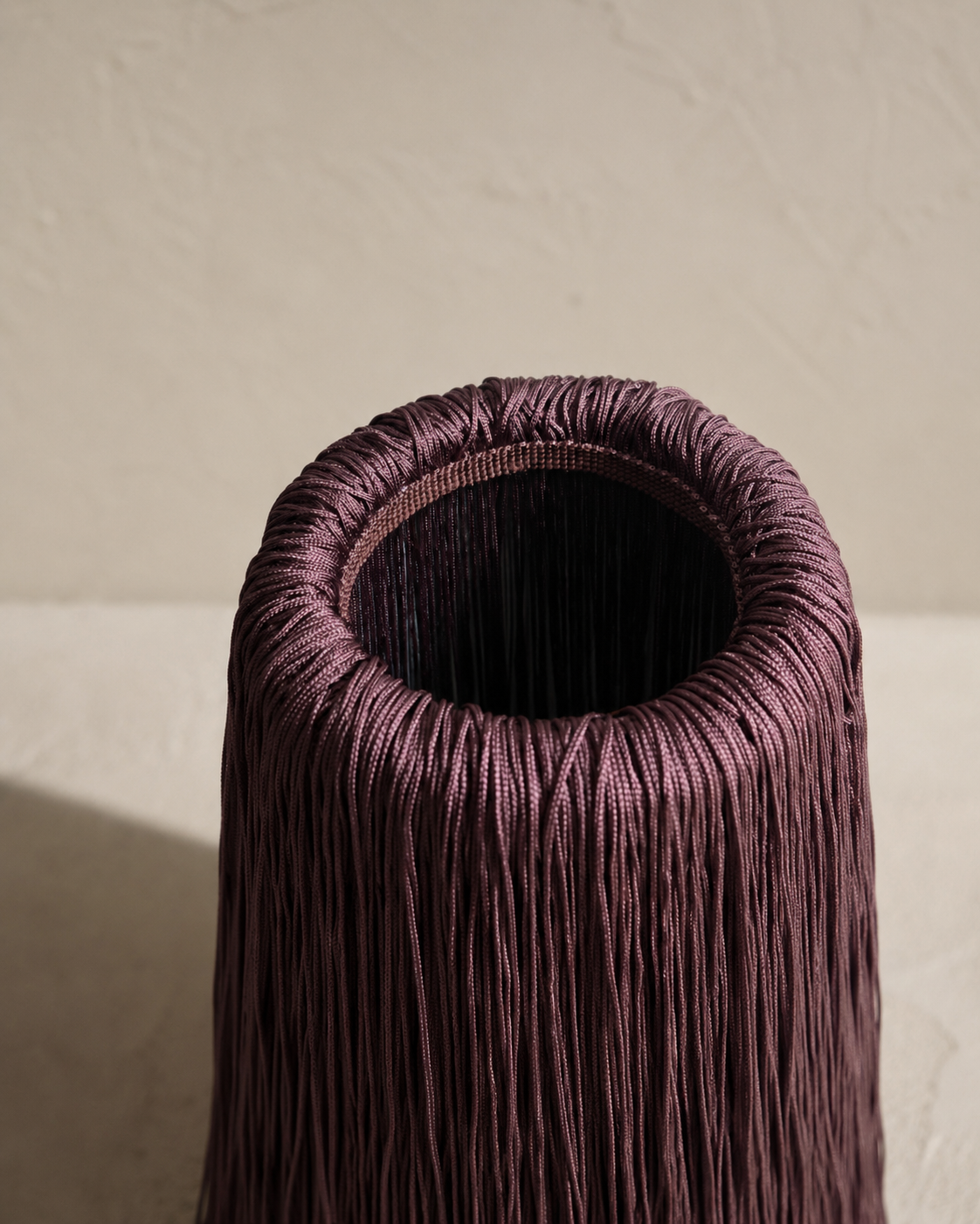 Close-up of fringe detail on Bordeaux Noir marble wine chiller, showing texture and depth.