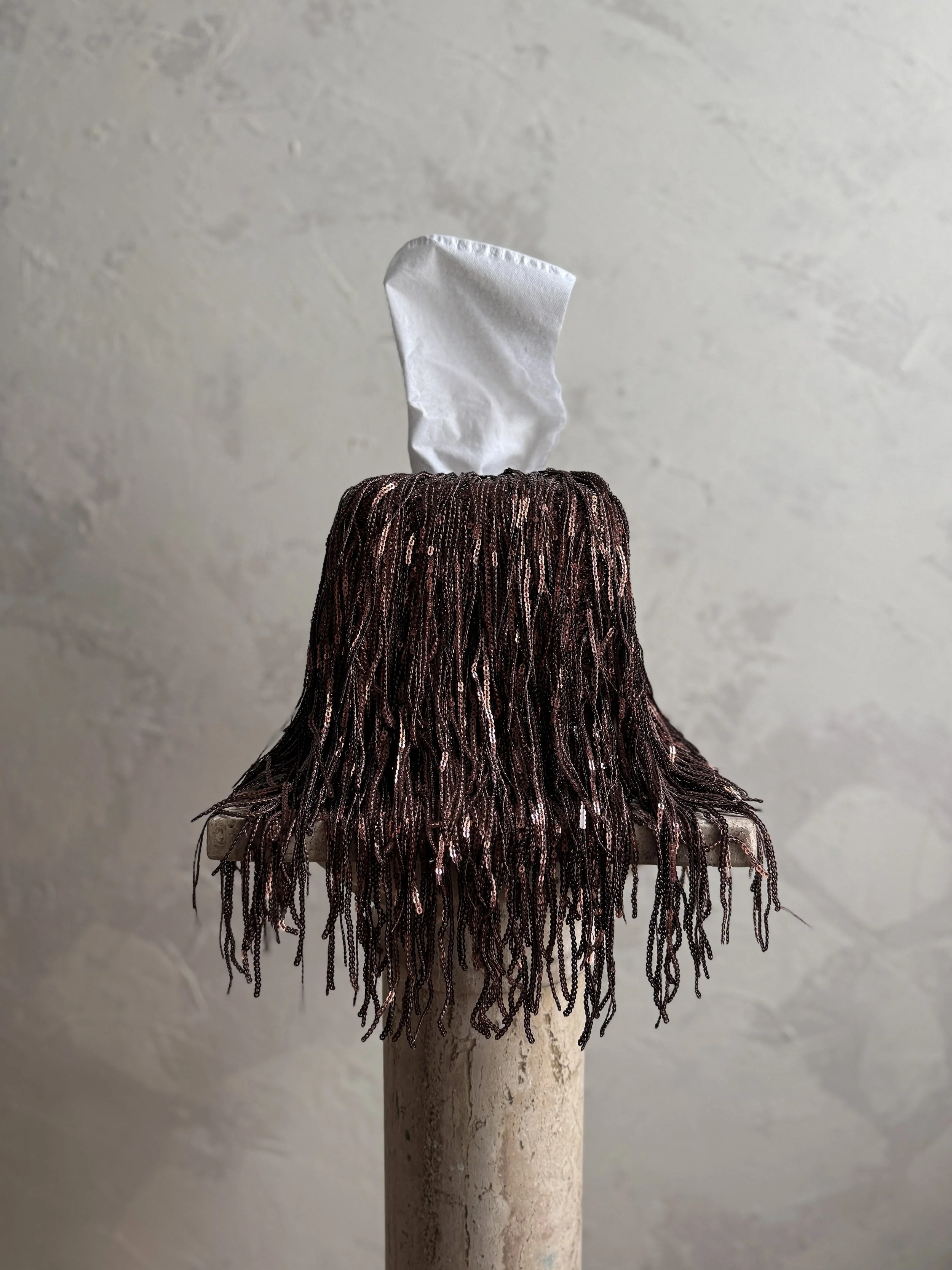 11:59 Limited Edition fringe tissue box cover in Last Call, featuring deep metallic bronze fringe with a sculptural drape
