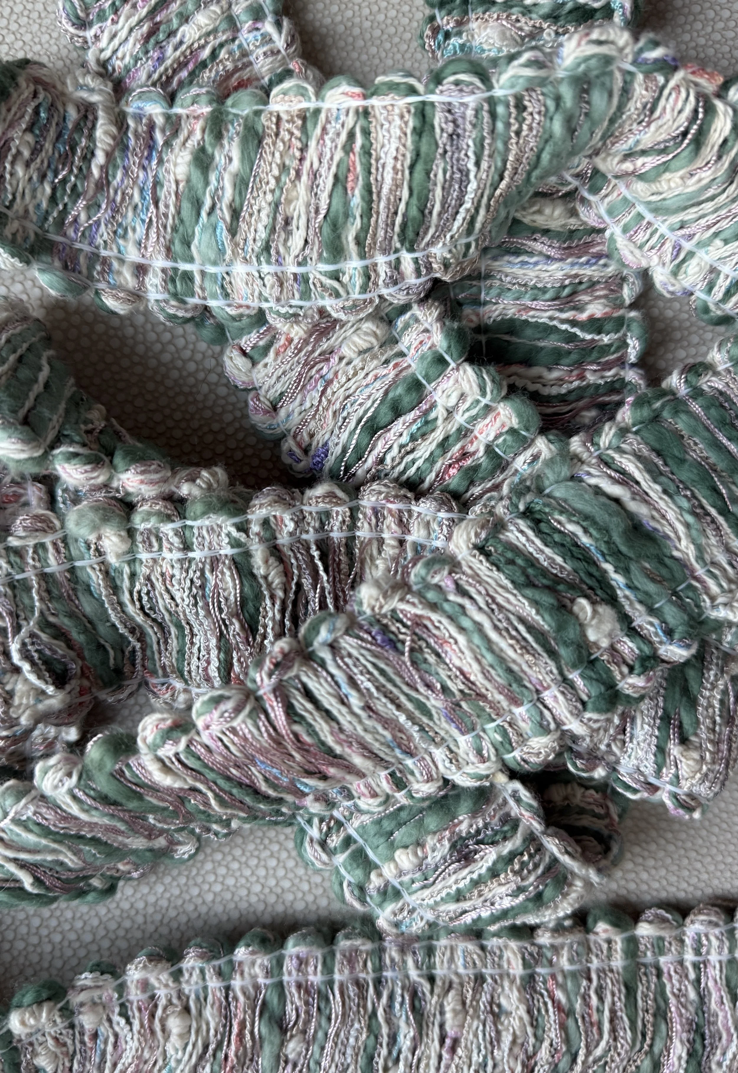 Close-up of looped fringe texture on the Soft Knit Tissue Box Cover, inspired by sweater knits.