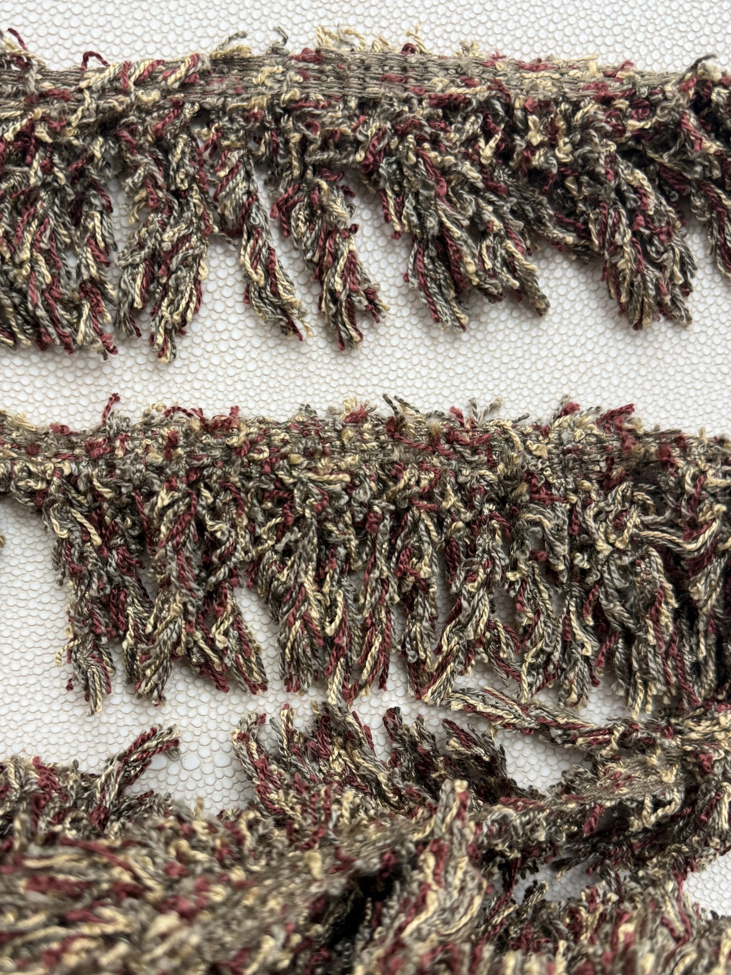 Seaweed Merlot fringe tissue box cover — sculptural home object wrapped in mossy olive and deep merlot tones with subtle cream threading