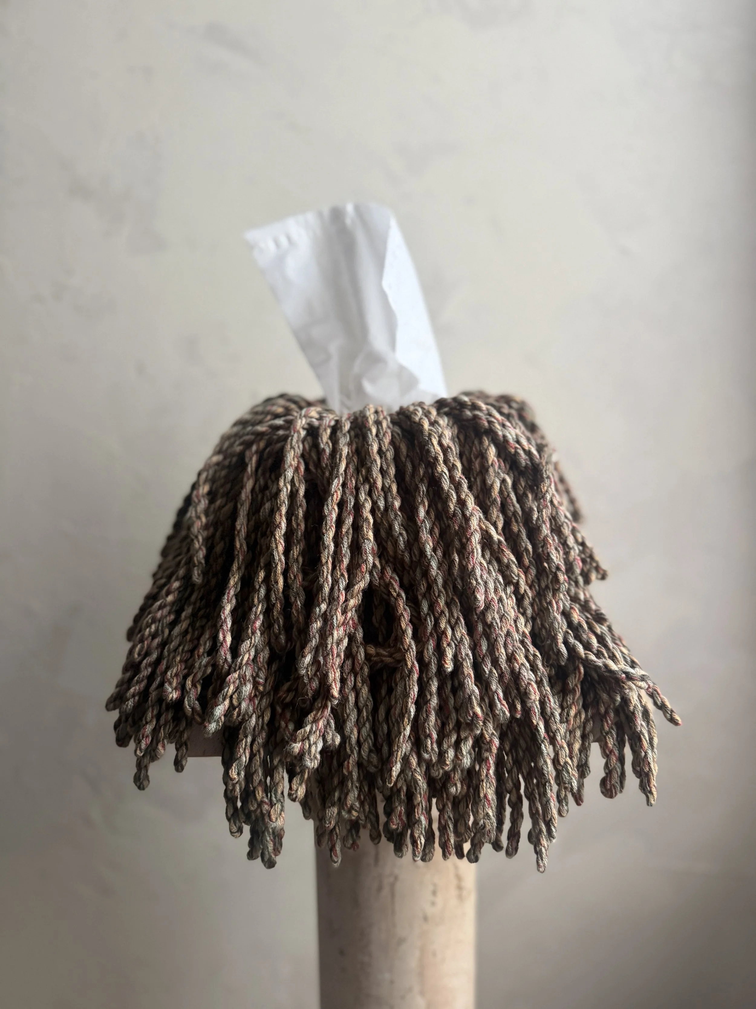 Meadow Knit Blend fringe tissue box cover wrapped in a green, merlot, sky-blue, and cream yarn blend — sculptural, textural, and handmade by Amber Renee Hansen.