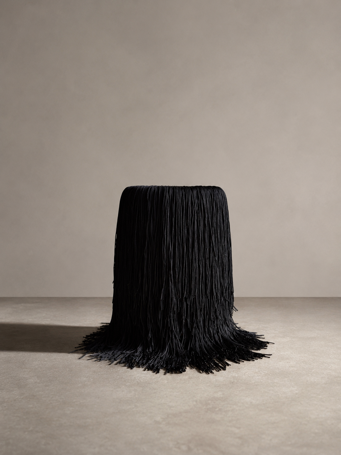 A black fringe marble wine chiller without a wine bottle, showcasing its elegant silhouette and fringe drape.
