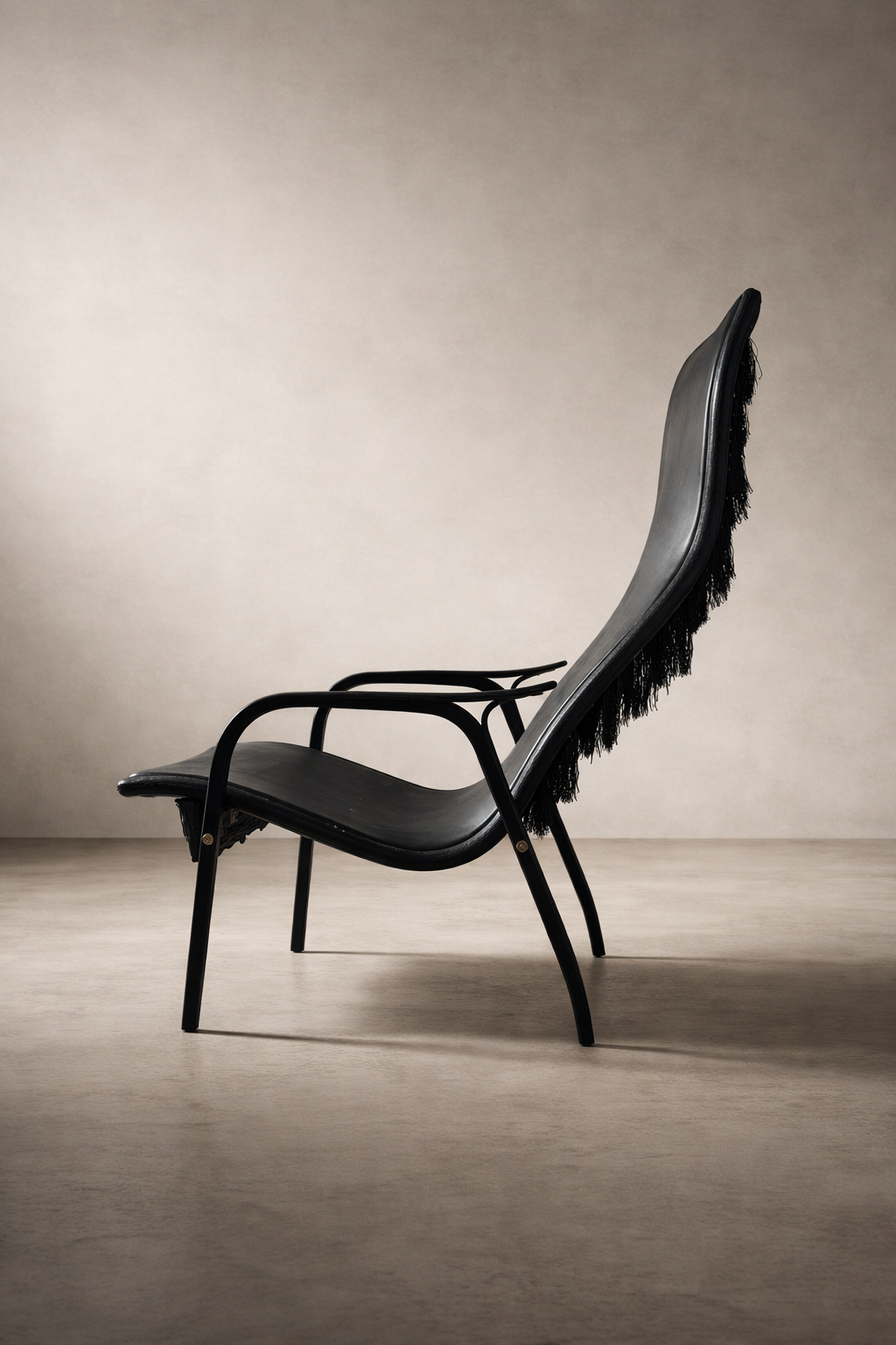 Lamino Lounge Chair in black leather with ebony oak frame and fringe back