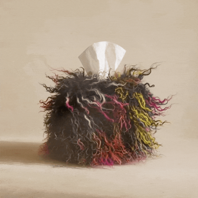 Spectrum Noir Mongolian lamb tissue box cover featuring luxurious black natural curls woven with an unexpected spectrum of color, photographed in an editorial studio setting.
