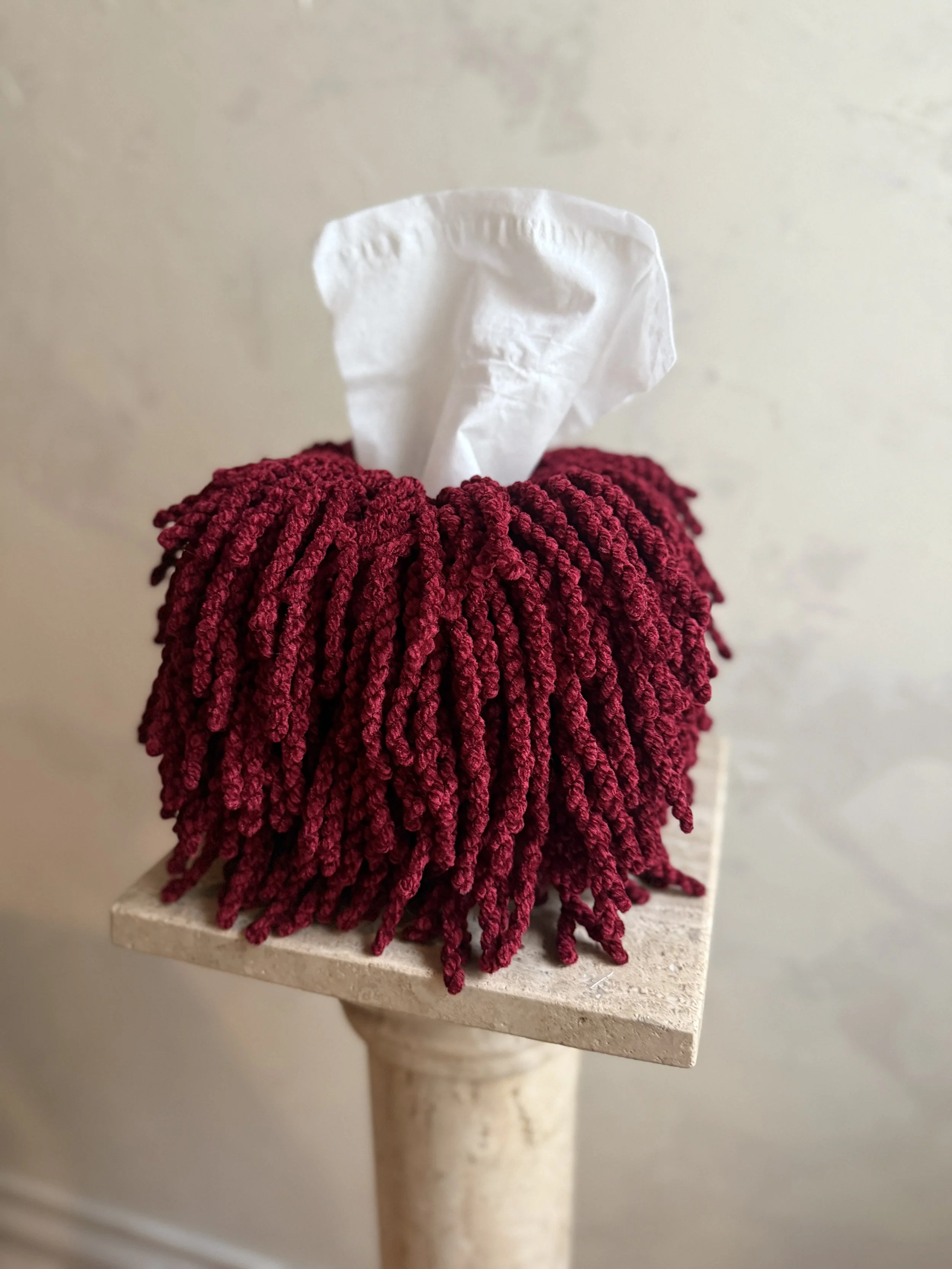 Textured oxblood fringe tissue box cover close-up