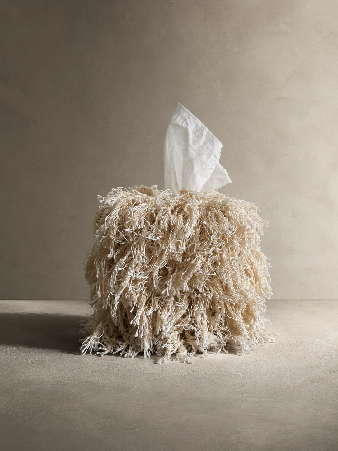 Luxury cotton fringe tissue box cover in Undone Muslin styled as a sculptural home accessory.
