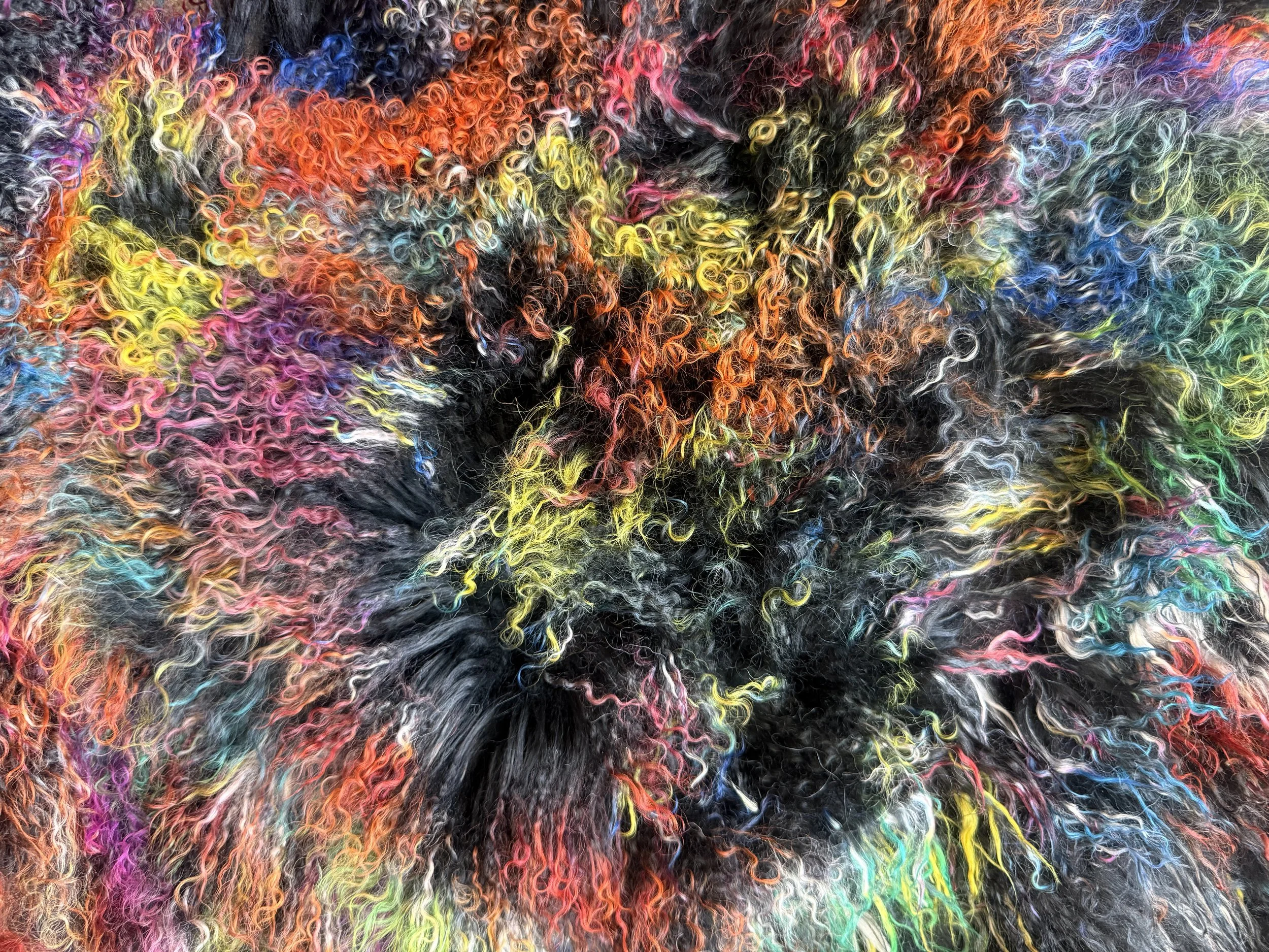 Spectrum Noir Mongolian lamb tissue box cover featuring luxurious black natural curls woven with an unexpected spectrum of color, photographed in an editorial studio setting.