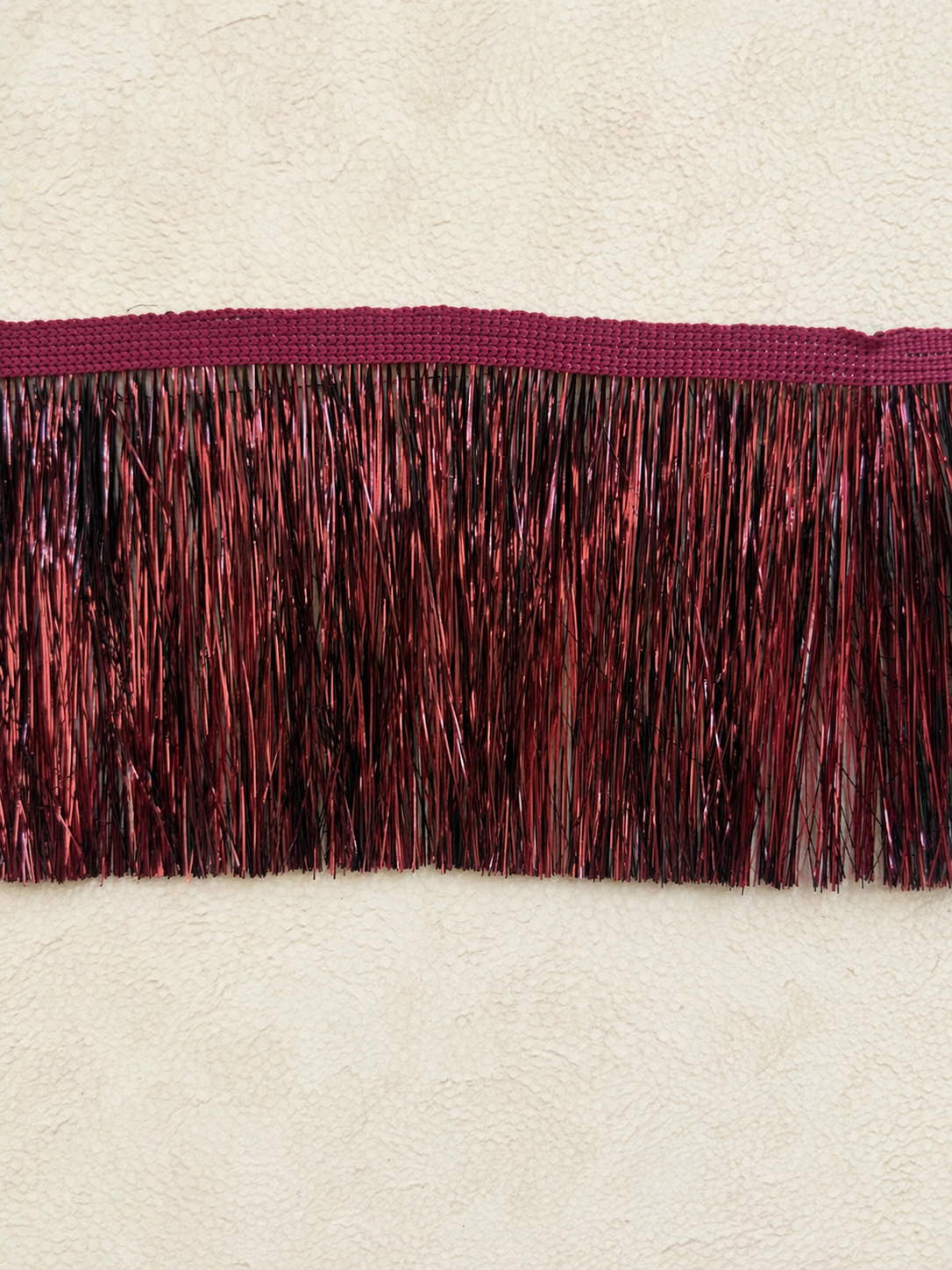Burgundy Static tinsel fringe tissue box cover with metallic texture and sculptural surface