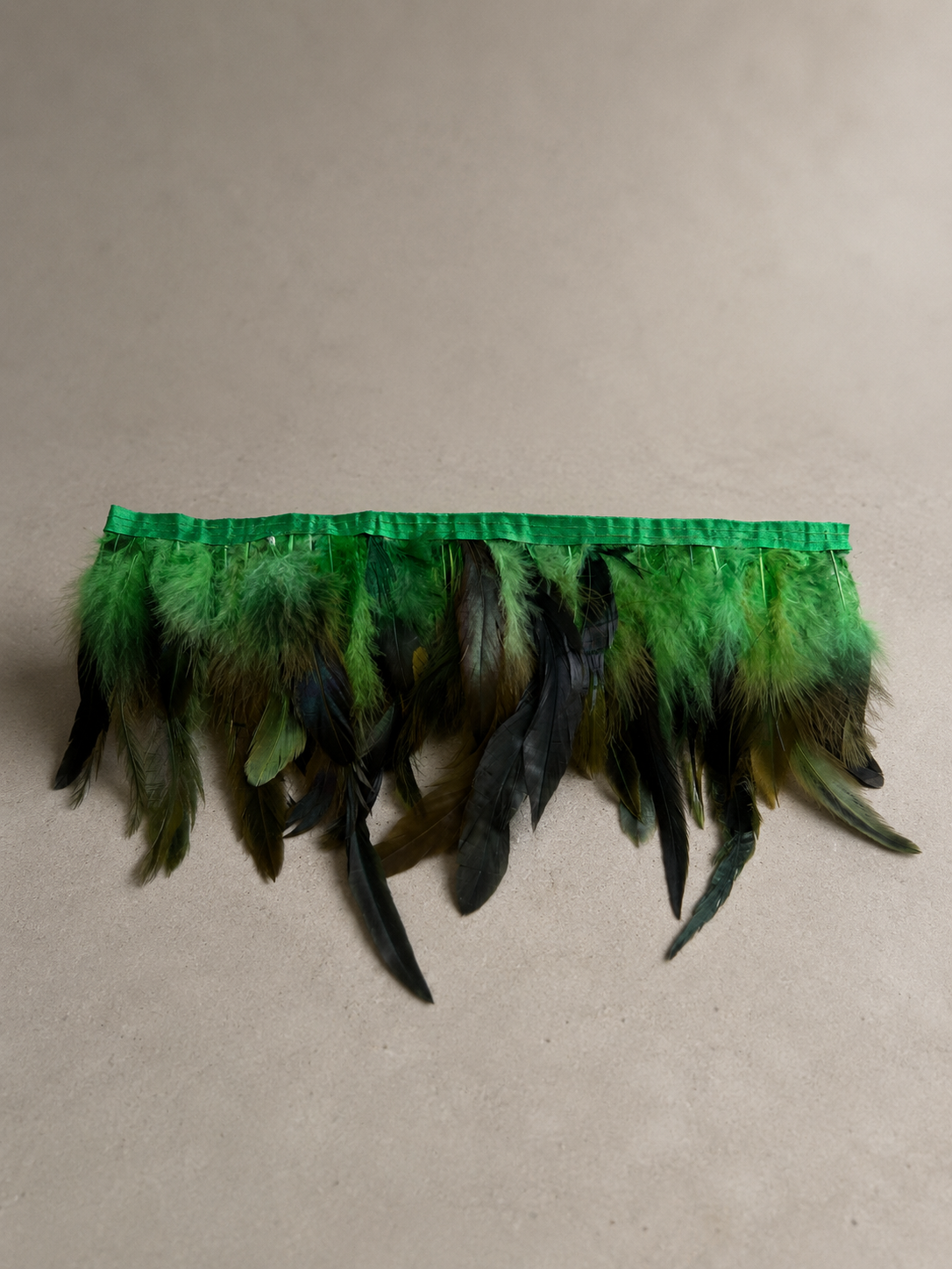 Close-up of green and black feather fringe from the Jungle Noir piec
