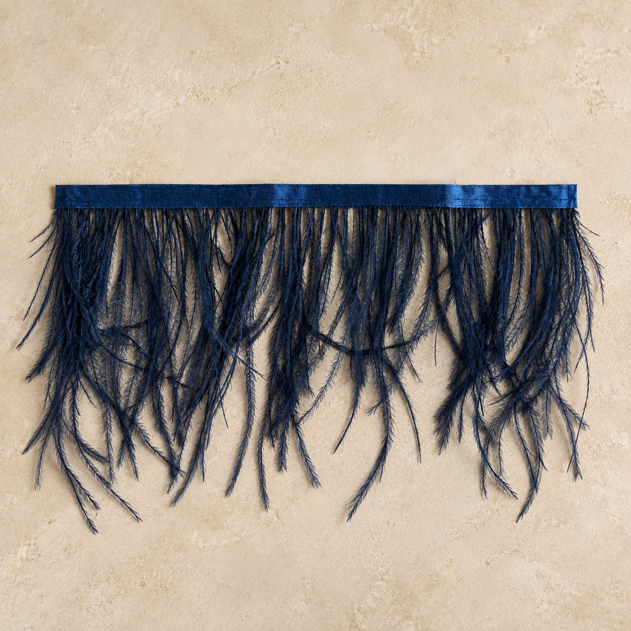 Midnight blue ostrich tissue box cover by Amber Renee Hansen on a warm neutral plaster background