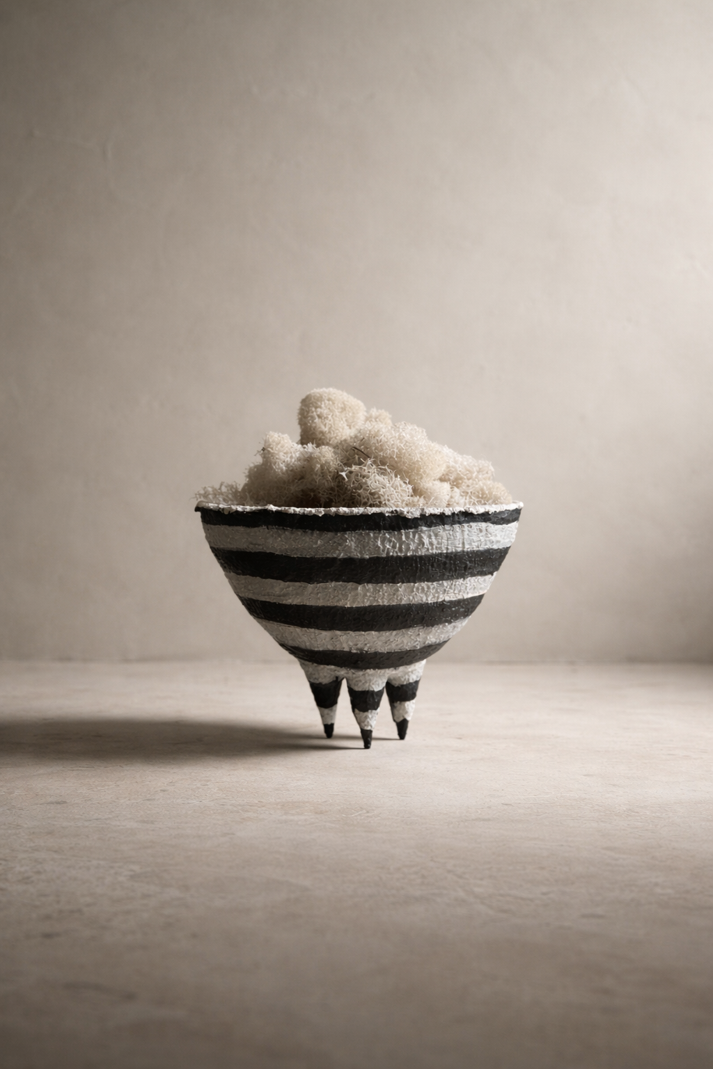 Black and white striped spiked bowl on studio background