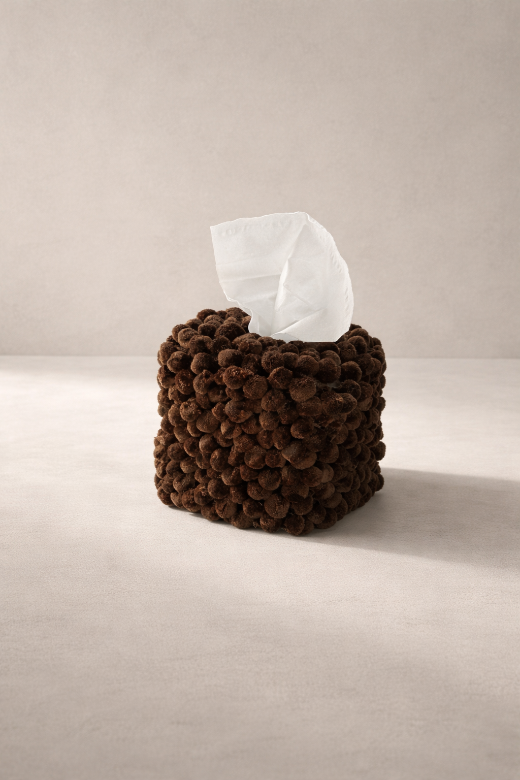 Cocoa Pom tissue box cover with rounded trim detail in warm brown.