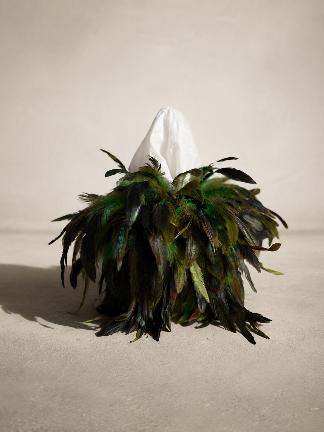Jungle Noir feather tissue box cover with layered green and black feathers extending outward