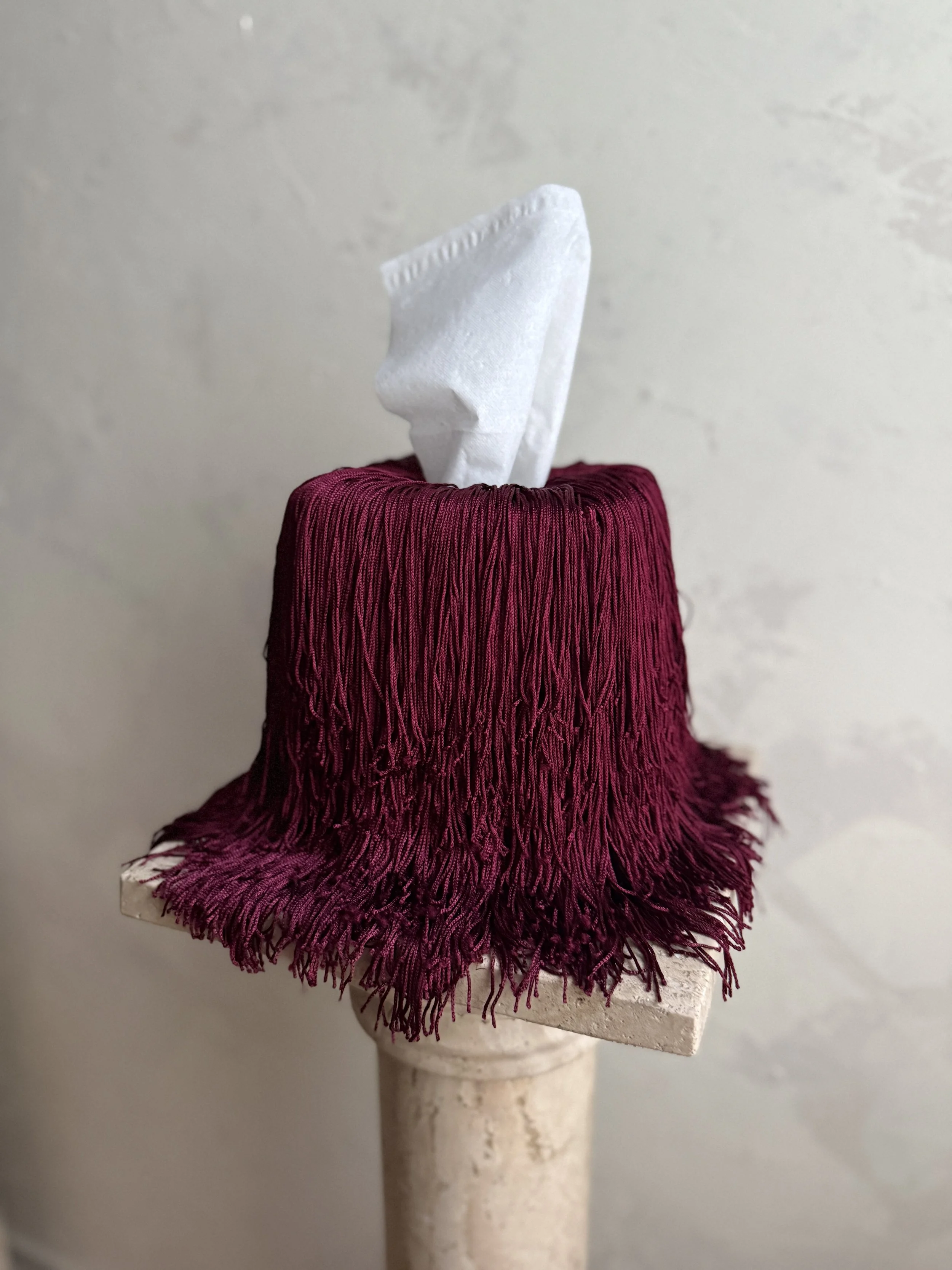 Deep Burgundy fringe tissue box cover draping elegantly with long fringe from the Spill Edit by Amber Renee Hansen.