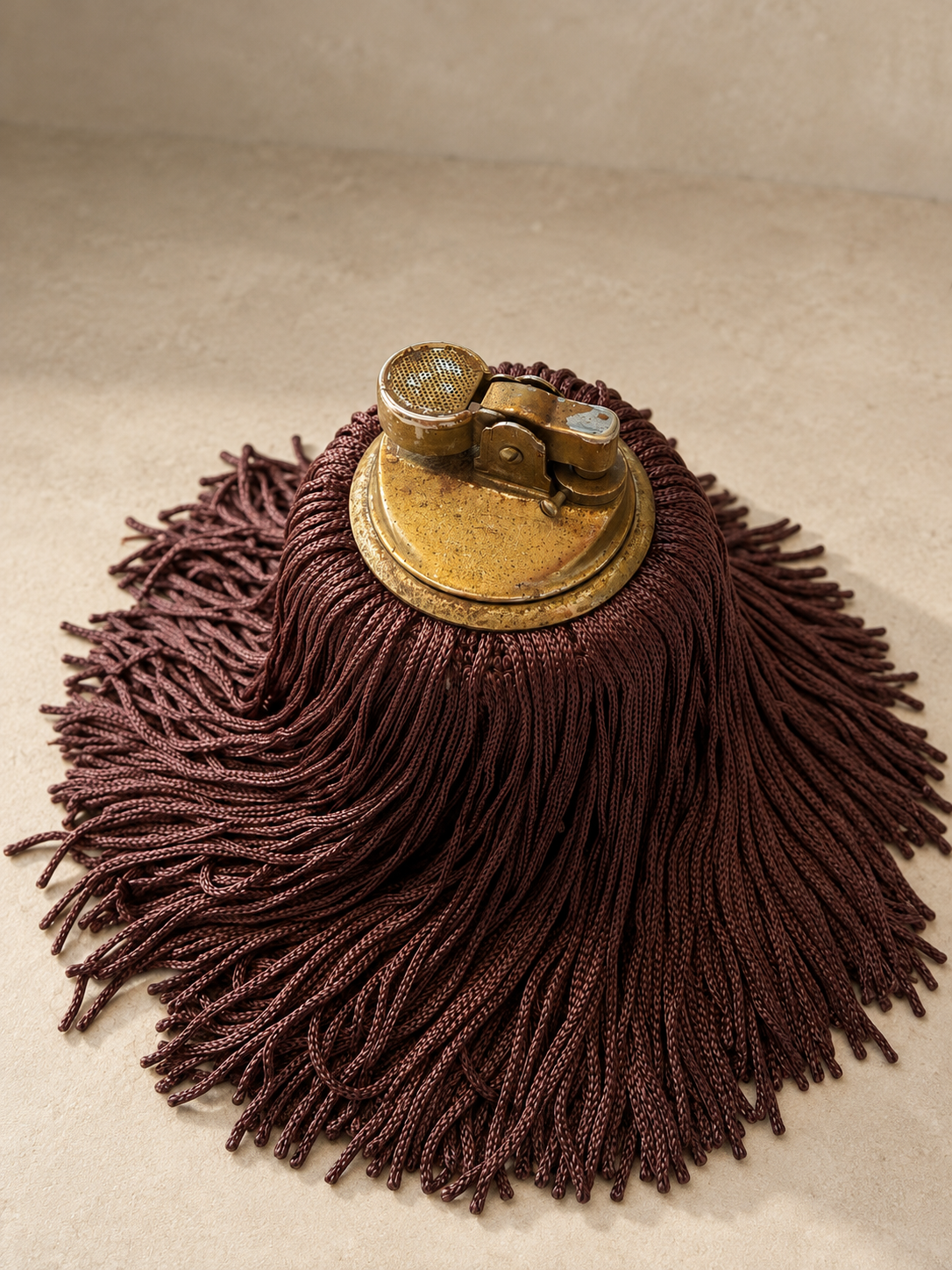 Bordeaux Noir Fringe Lighter by Amber Renee Hansen, a vintage onyx table lighter reinvigorated with cascading deep burgundy fringe, photographed in a minimal editorial setting.