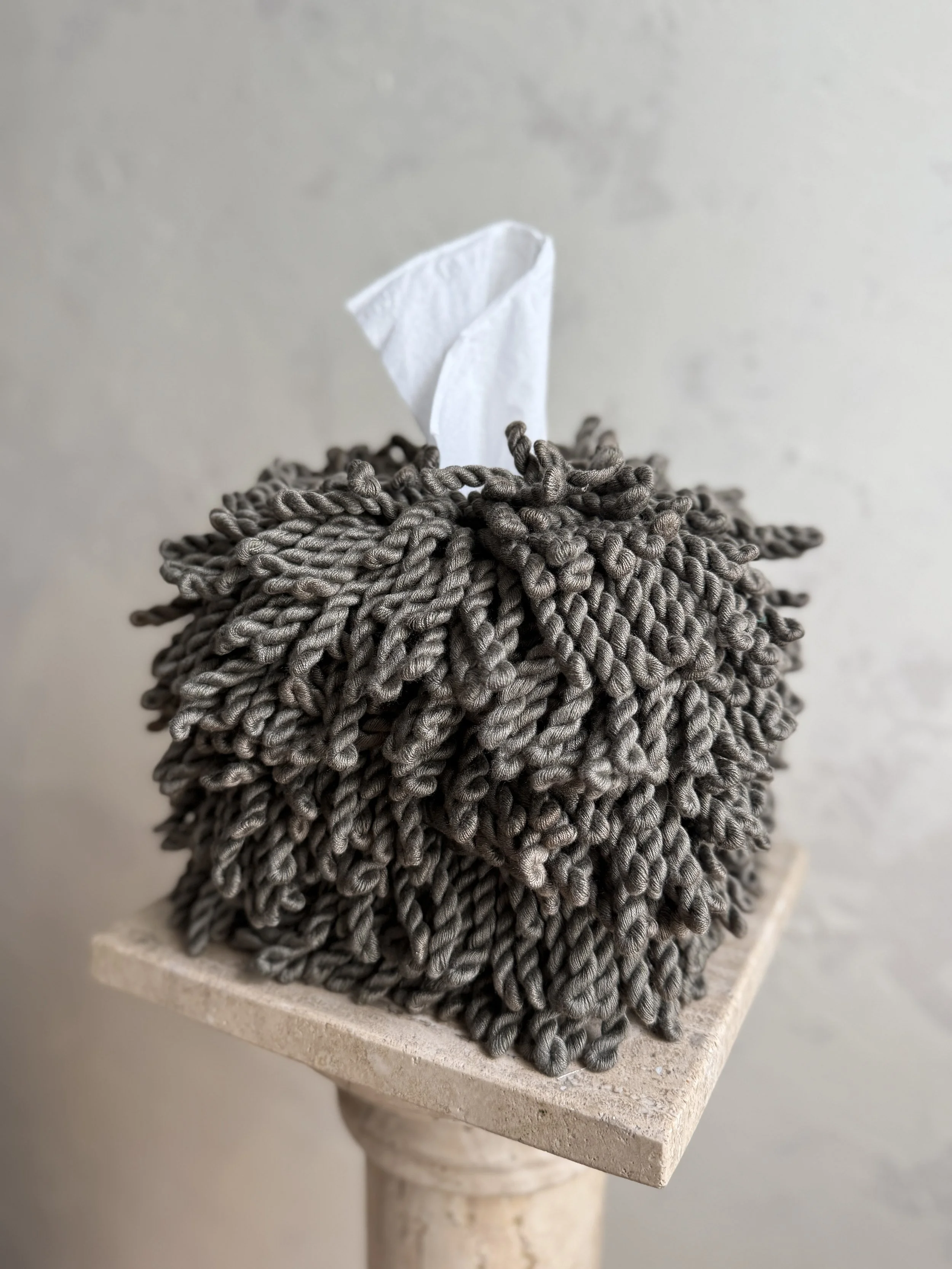 Earthy olive fringe tissue box cover designed by Amber Renee Hansen, featuring long-pile fringe and quiet luxury details.