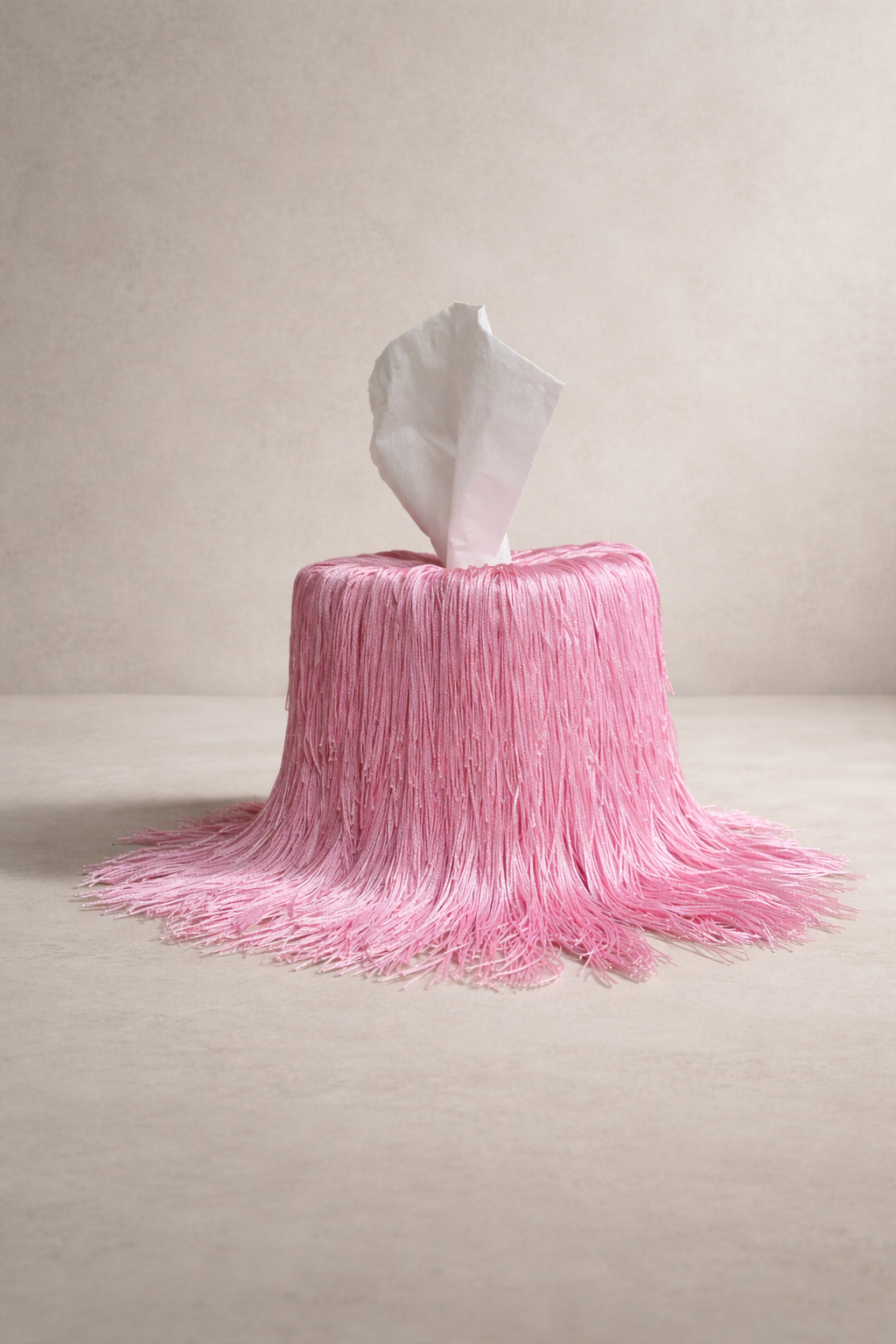 Pink in Motion fringe tissue box cover from the Spill Edit, hand-wrapped in soft blush fringe.