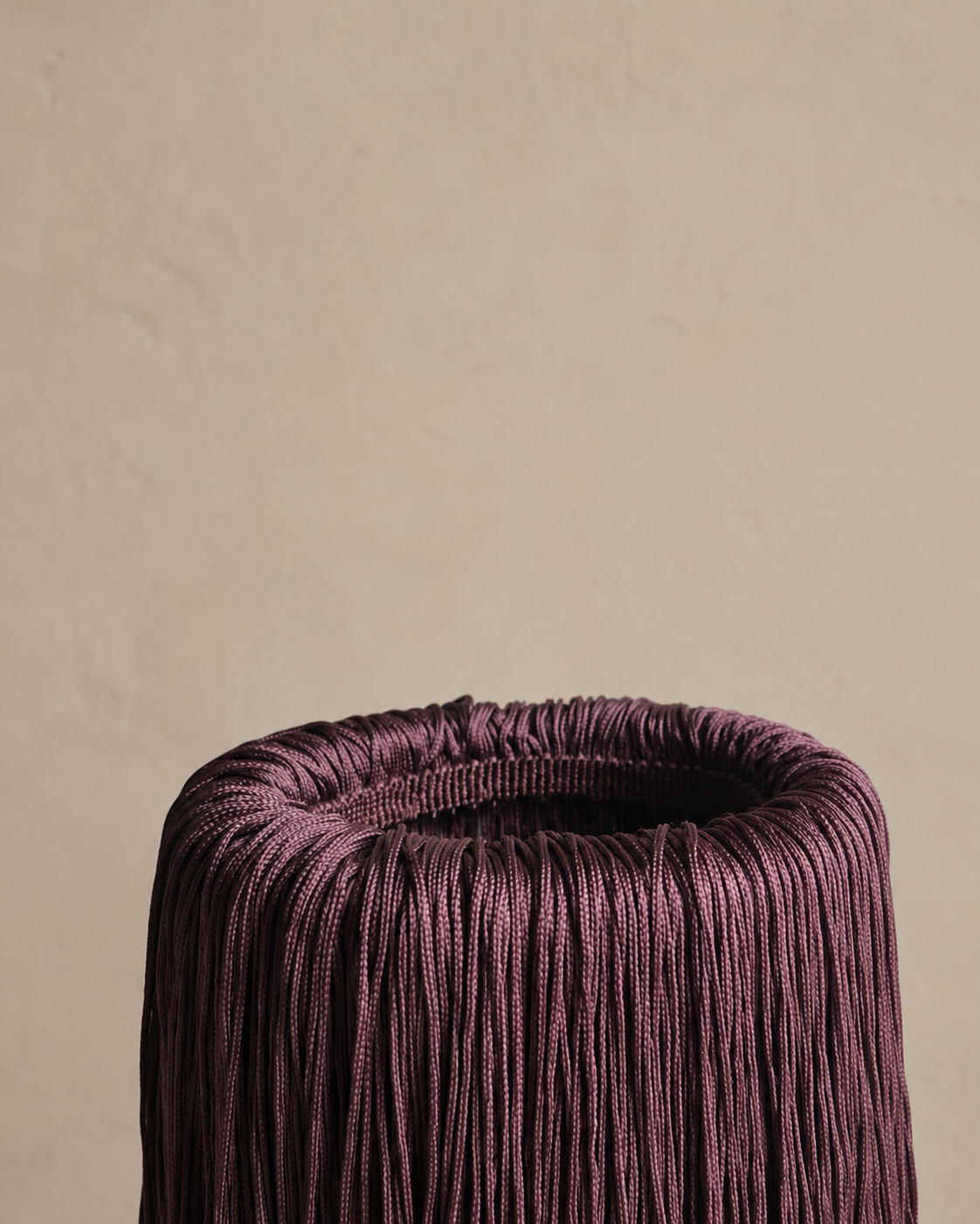 Close-up of fringe detail on Bordeaux Noir marble wine chiller, showing texture and depth.