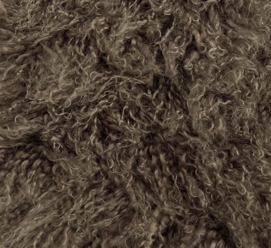 Wing Span Mongolian Lamb Bench in Smoked Taupe featuring a dark espresso metal crossed frame, photographed in a quiet neutral setting