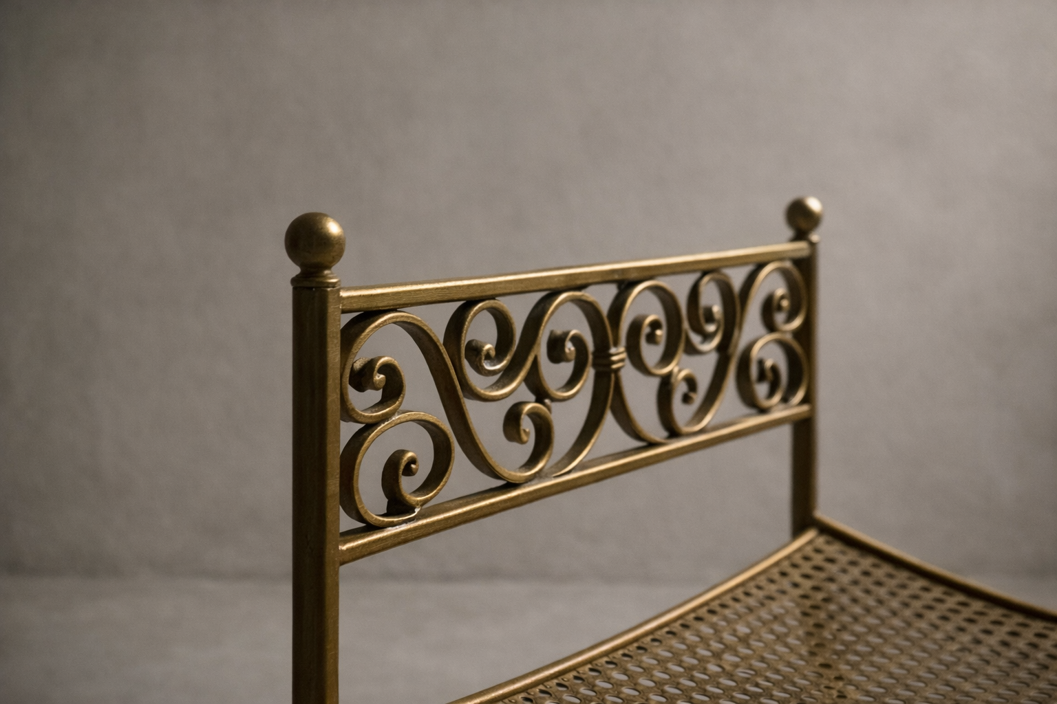 Pair of vintage Hollywood Regency gold curule benches with scrollwork and X-frame bases in a neutral studio setting.