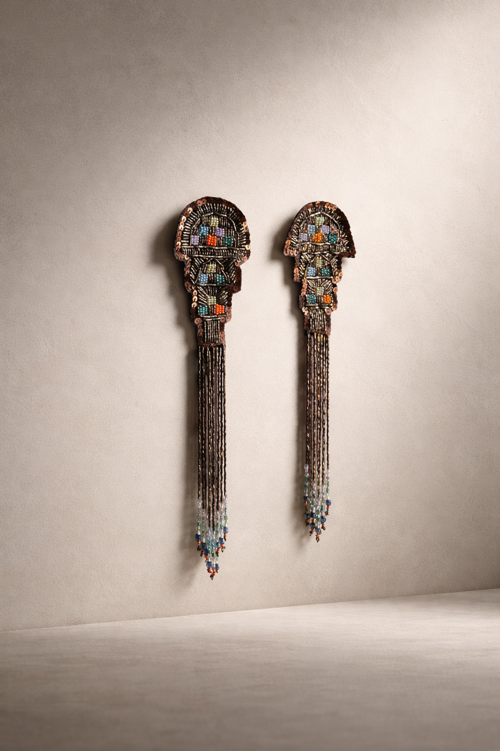 Close-up view of the interchangeable tassel adornments on The Female Edit artwork, showing intricate detail and texture by Amber Renee Hansen.