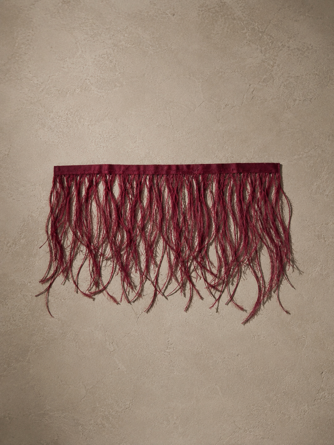 Luxury burgundy ostrich feather tissue box cover with genuine ostrich feathers.