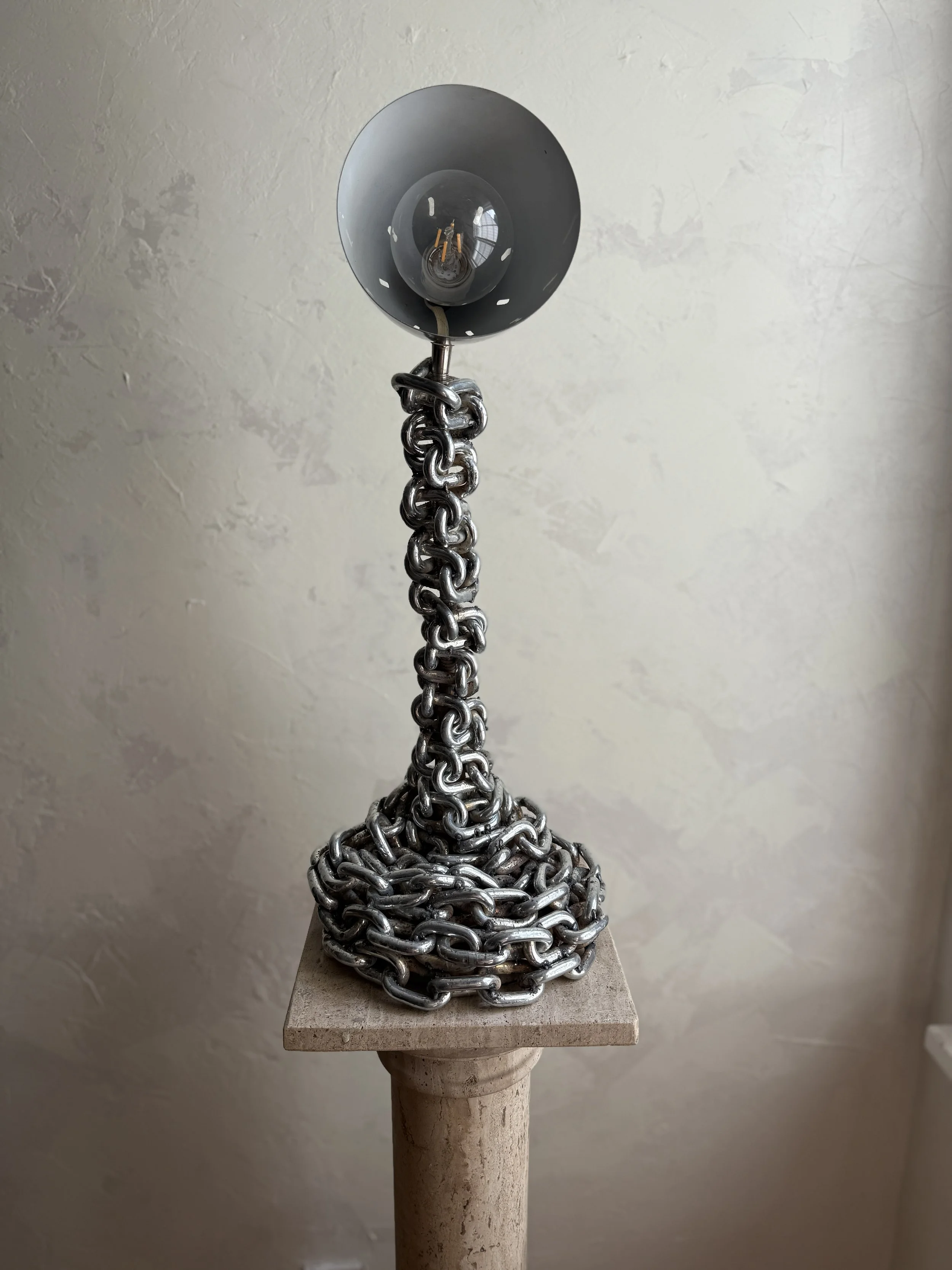Chain table lamp with fringe shade in warm, textural glow