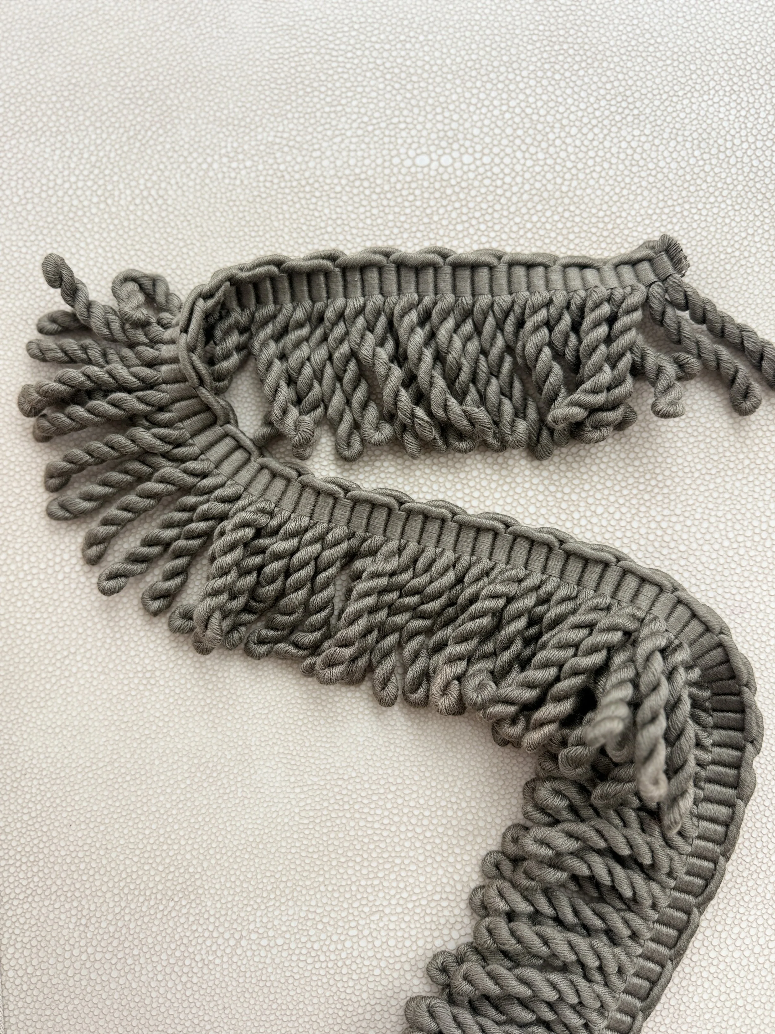 Earthy olive fringe tissue box cover designed by Amber Renee Hansen, featuring long-pile fringe and quiet luxury details.