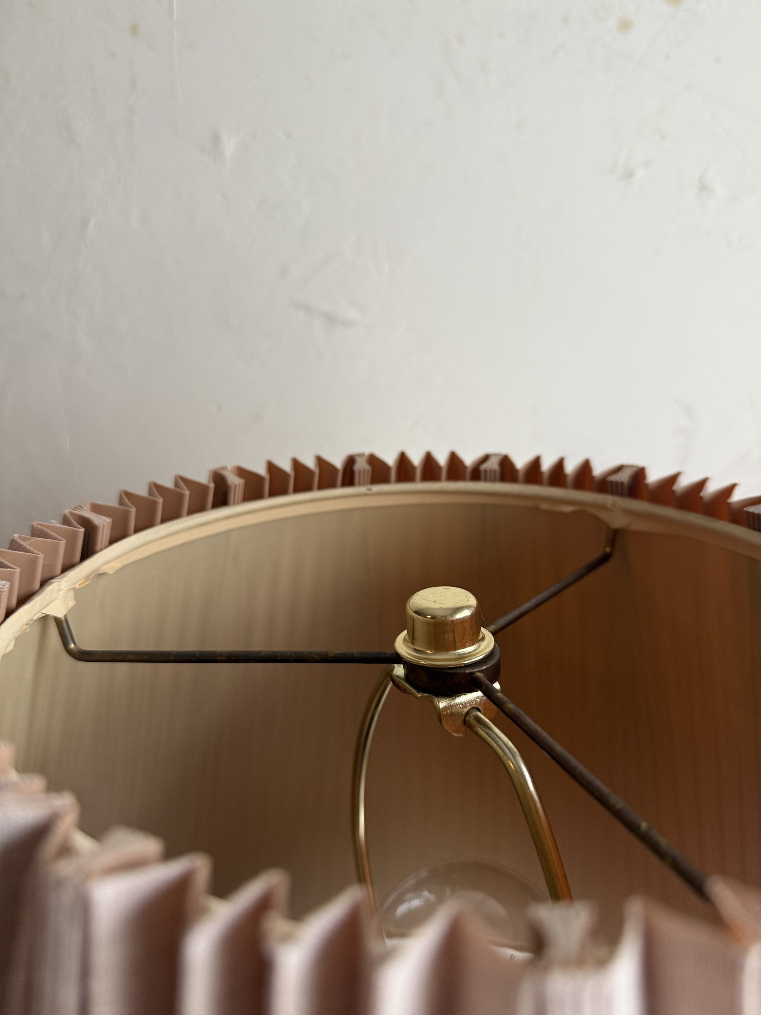 Designer sheepskin table lamp featuring natural curl and pleated shade.