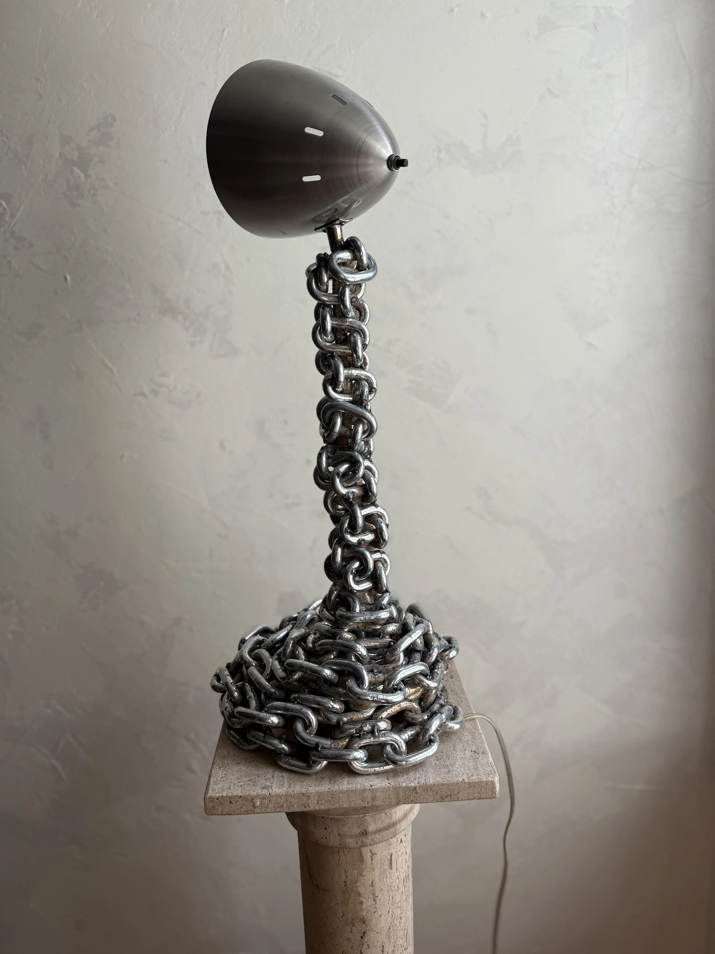 Chain table lamp with fringe shade in warm, textural glow