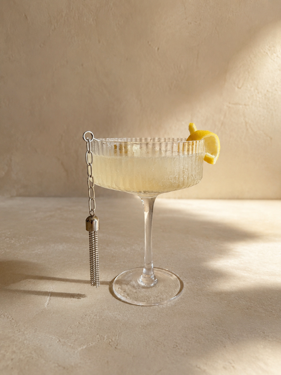 Tassel Cocktail Picks by Amber Renee Hansen featuring four stainless steel cocktail picks with silver-plated brass tassels, displayed in a stainless steel holder.