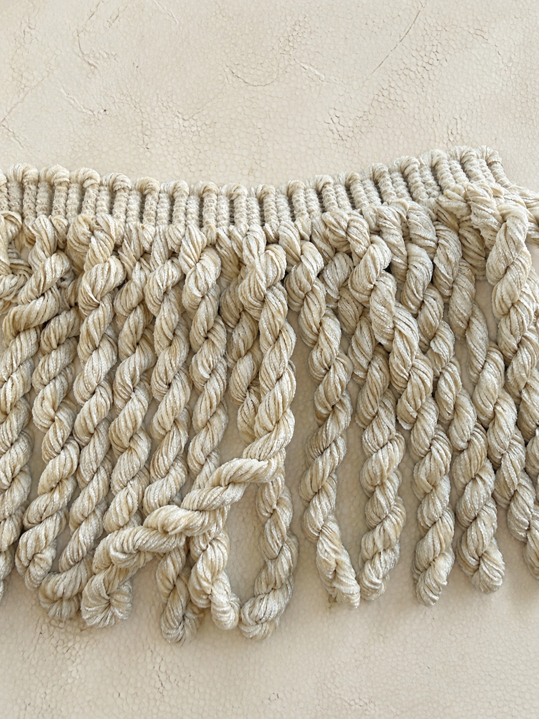 Twisted Oat Luxe fringe tissue box cover in soft oat with chunky twisted fringe, handcrafted by Amber Renee Hansen.