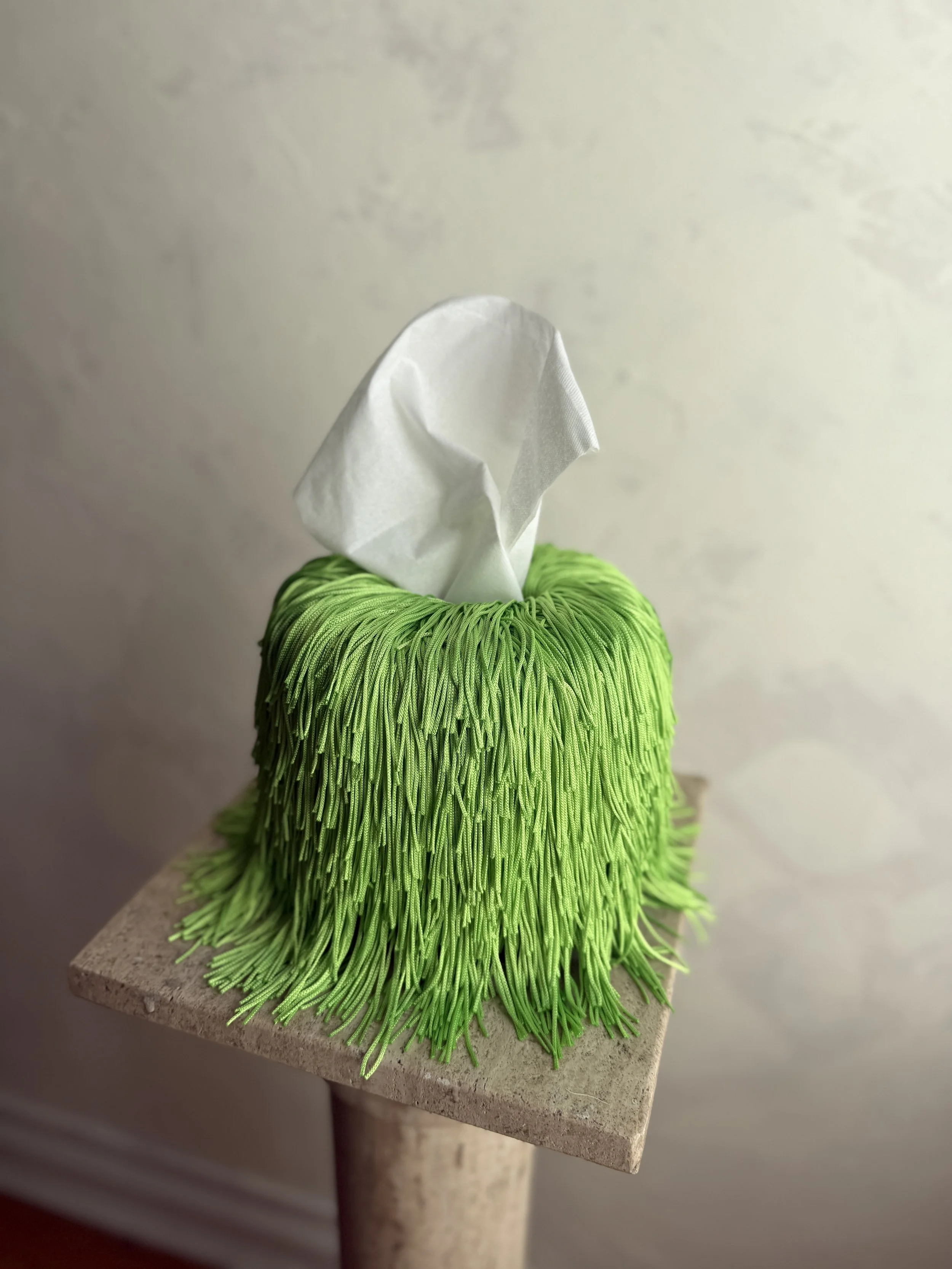 Soft Electric Green Fringe Tissue Box Cover — Spill Edit with round-form ceramic base and hand-wrapped layered fringe, designed by Amber Renee Hansen.