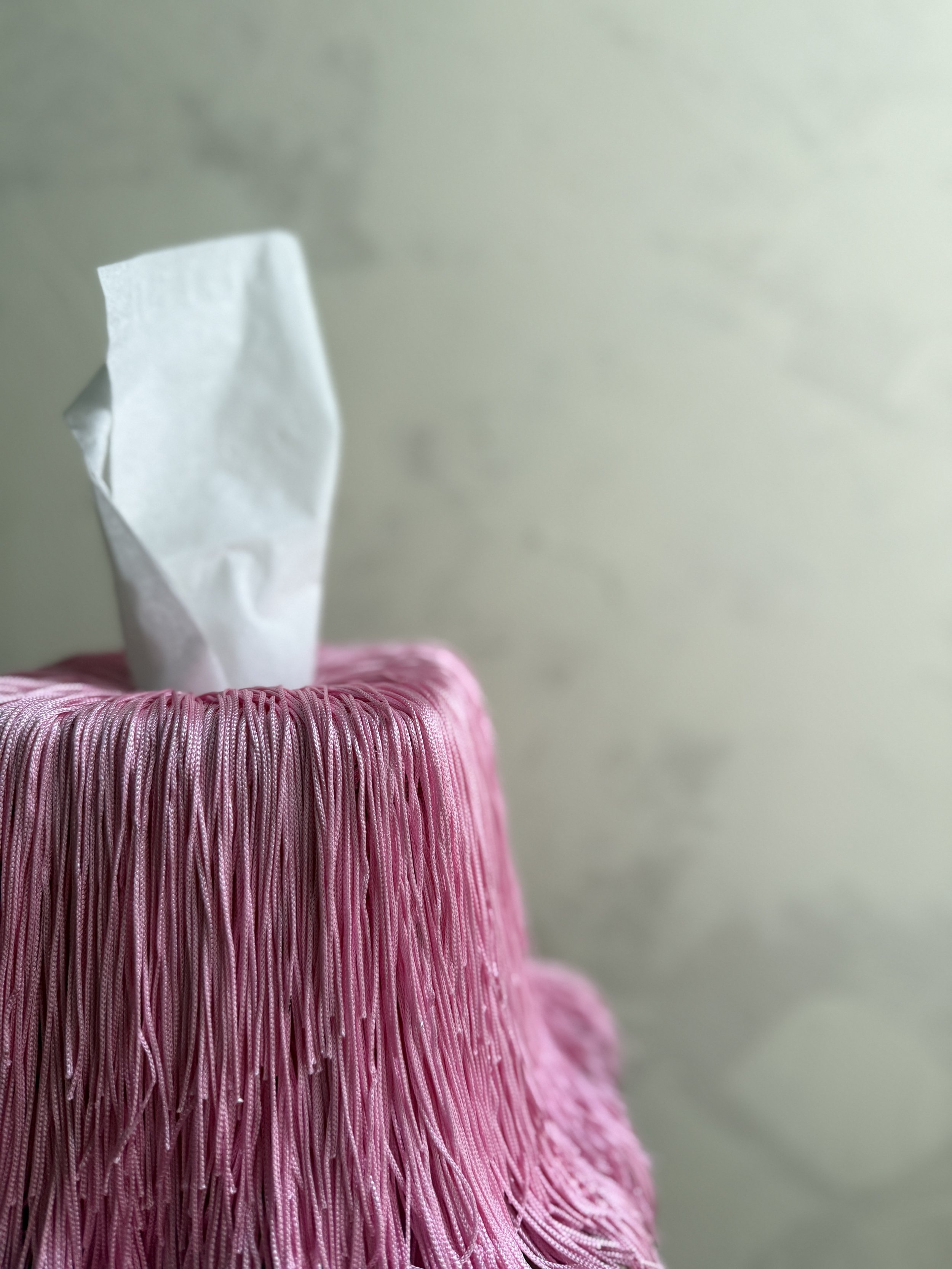 Pink in Motion fringe tissue box cover from the Spill Edit, hand-wrapped in soft blush fringe.